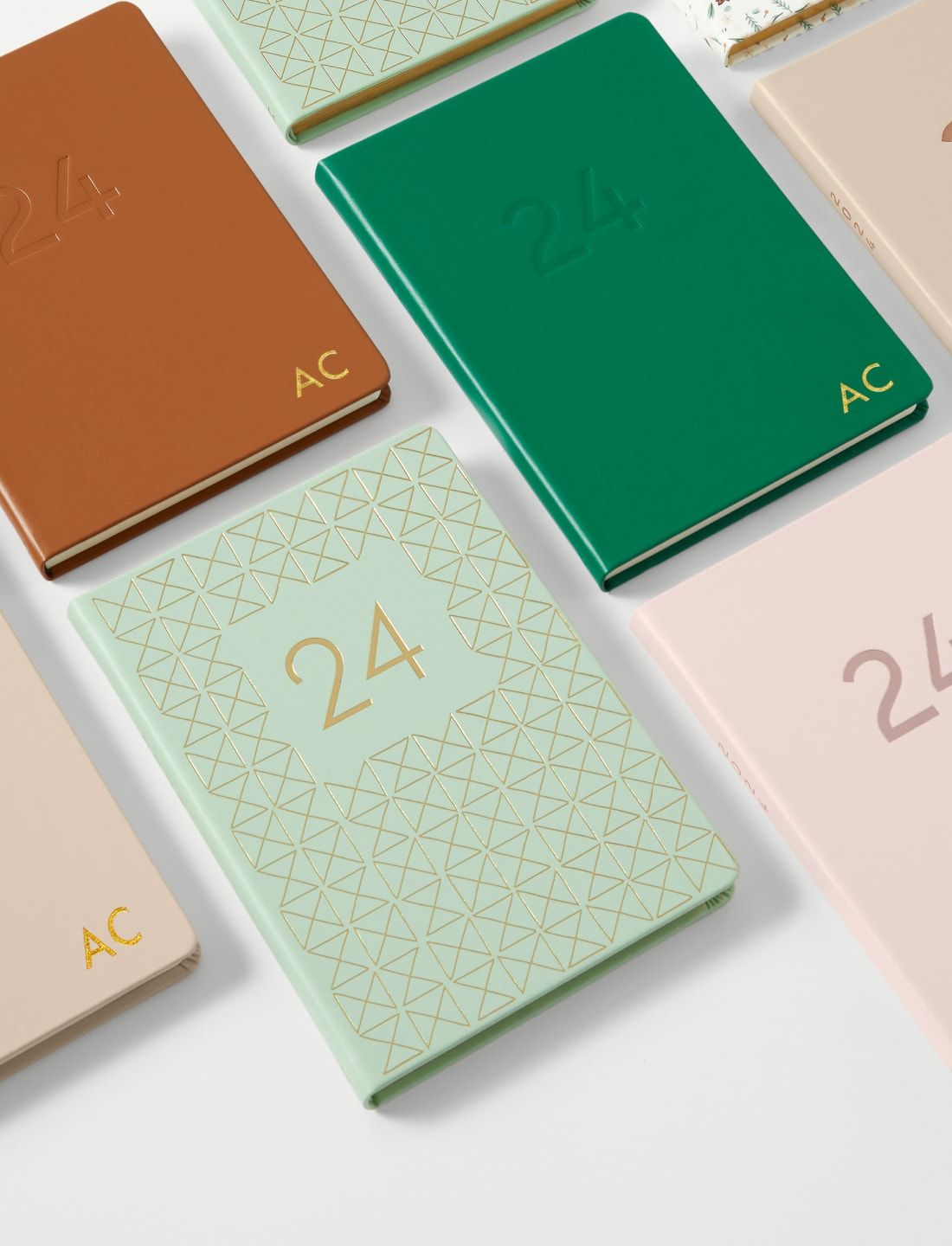 a group of notebooks with monograming 