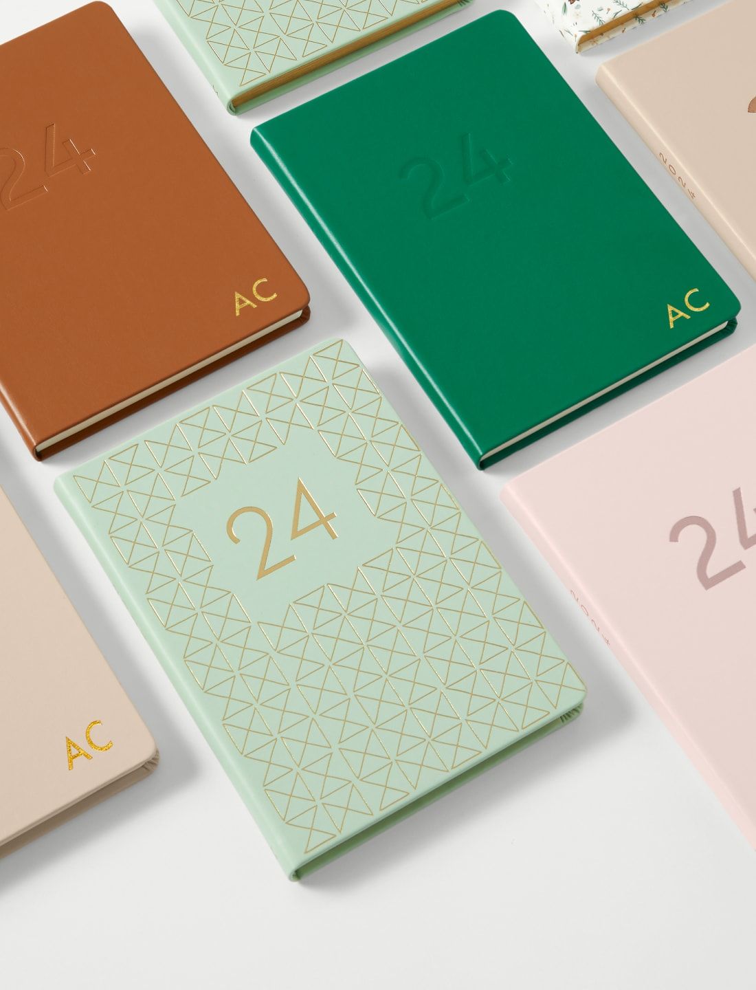 a group of notebooks with monograming