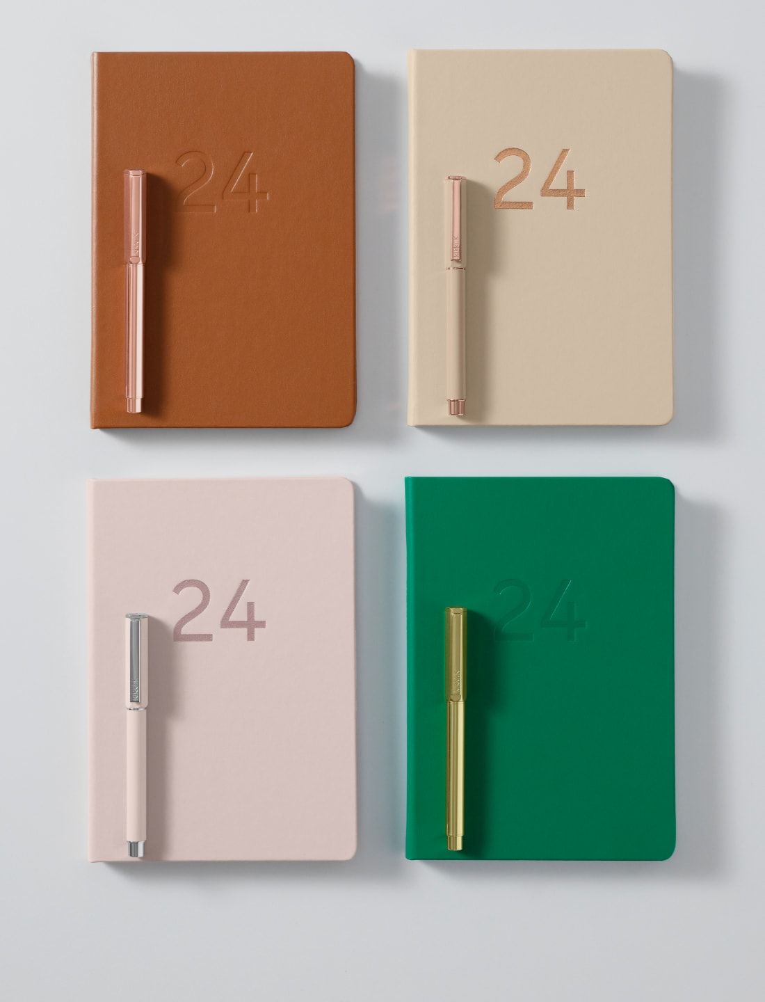 a group of notebooks with a pen