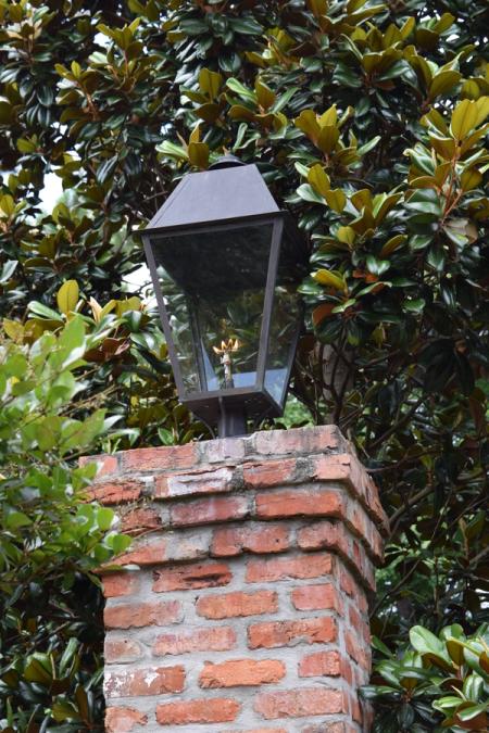 Gas lantern bolted flat onto the top of a brick pier