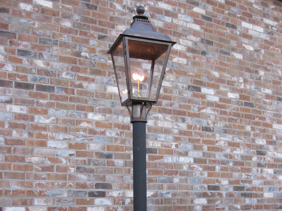 Gas lantern on a round lamp post with a post fitter collar