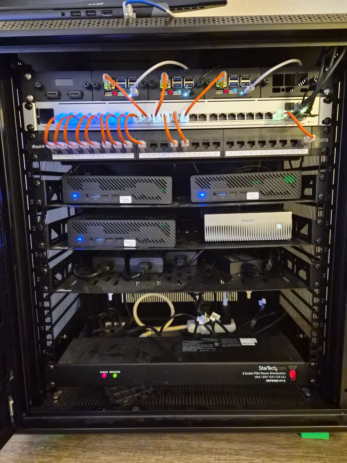 Server rack with three Minisforum MS-01 systems and an ASUS Ascent.