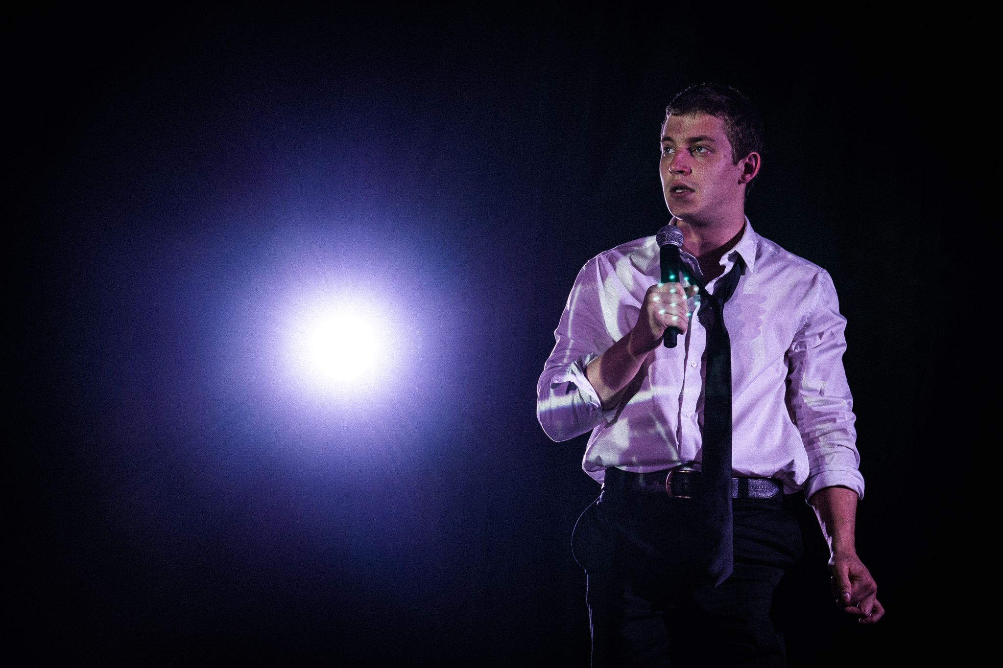 Man with a microphone and a blue light