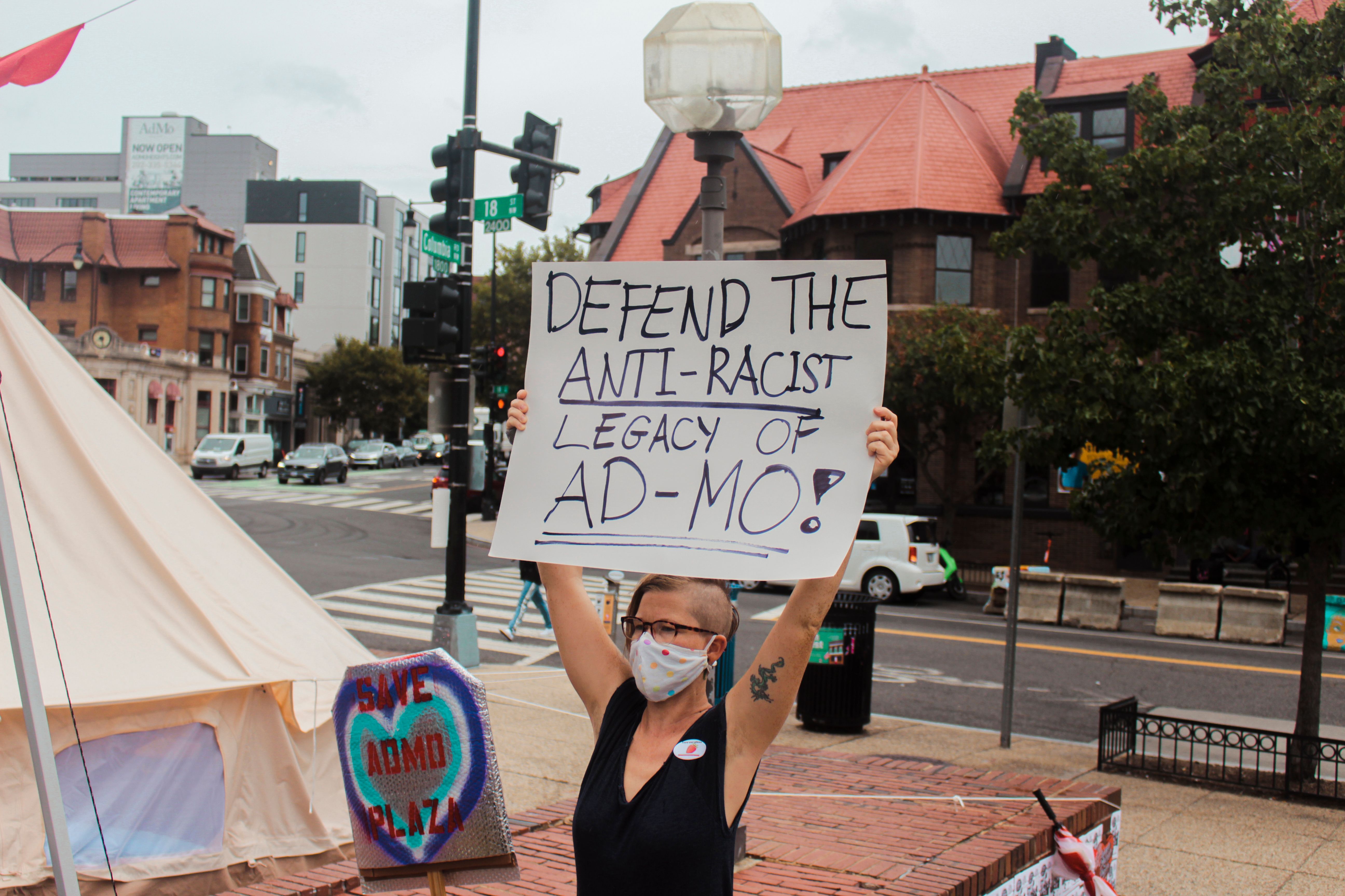 A plaza protector holds a sign in defense of the anti-racist legacy of AdMo (Adams Morgan) at the rally on September 22nd, 2021. 