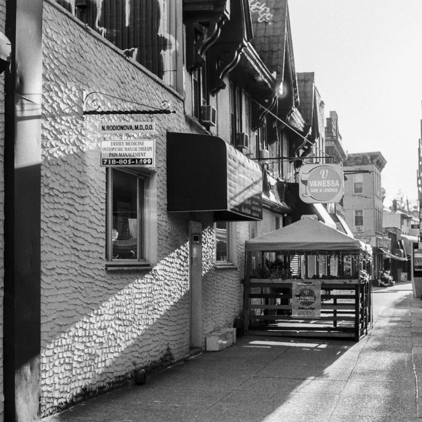 black and white image of a street in Queens