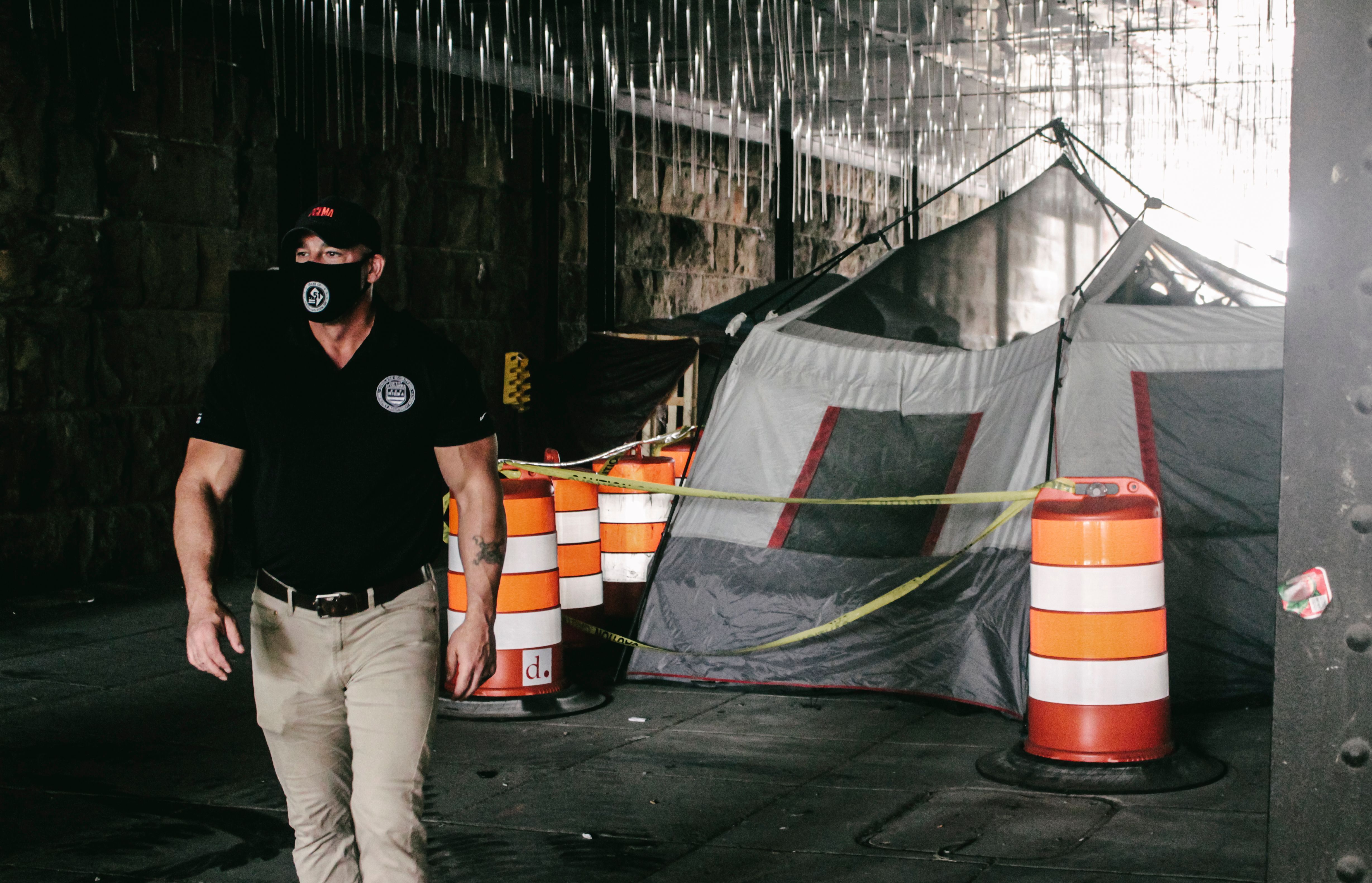 Deputy Mayor for Public Safety and Justice Christopher Geldart wearing HSEMA clothing while walking through the taped off underpass at M & 2nd St. NE. 