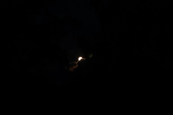 the moon behind clouds