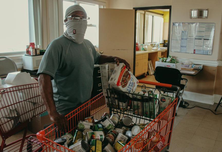 Boe in the community room with some of the foodstuffs available to residents.