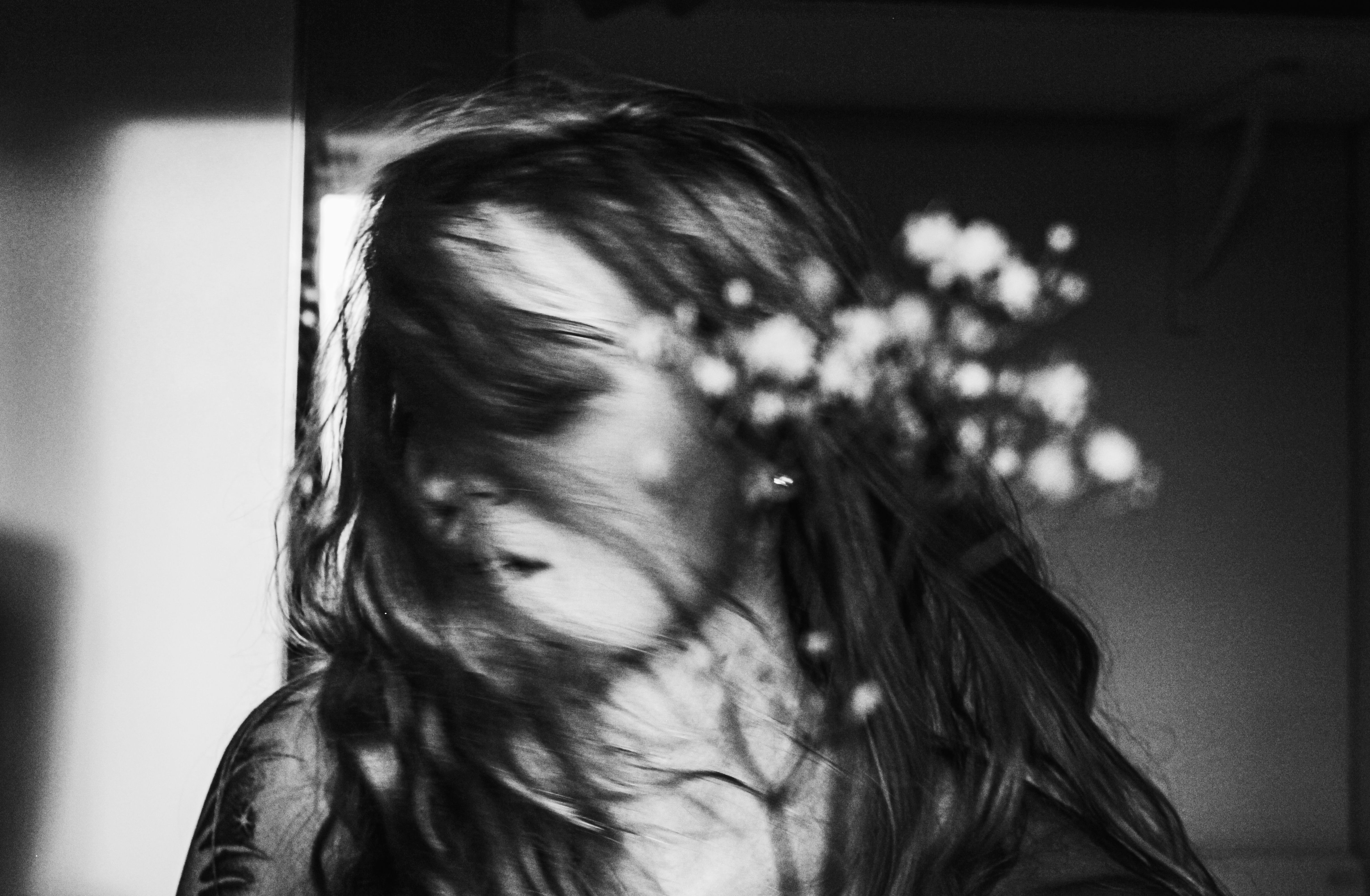 blurred closeup of woman, flower