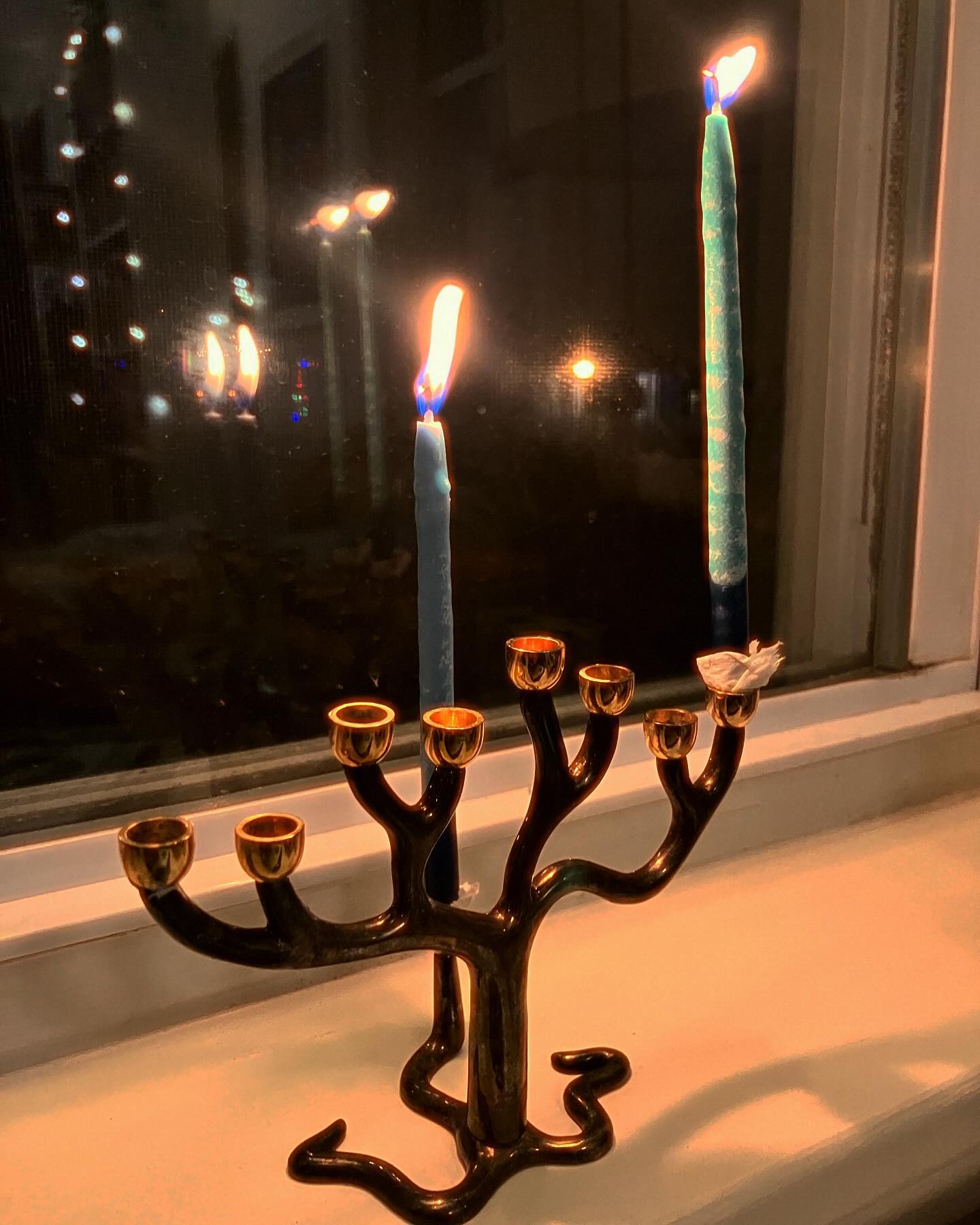 a menorah with the first candle lit