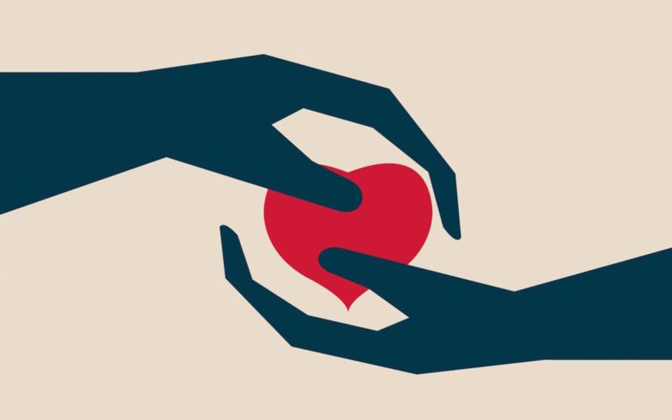 hands coming together over a heart