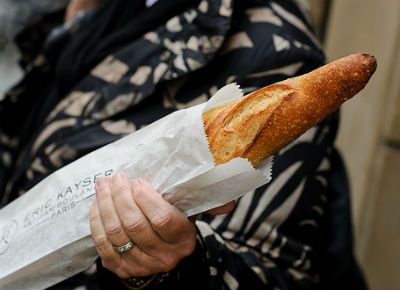 woman on chair outside, lake in background