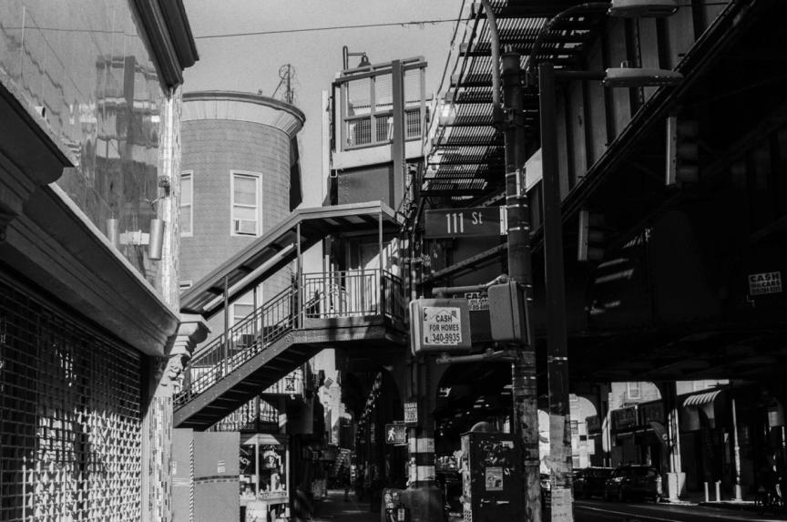 black and white image of subway overpass in Queens