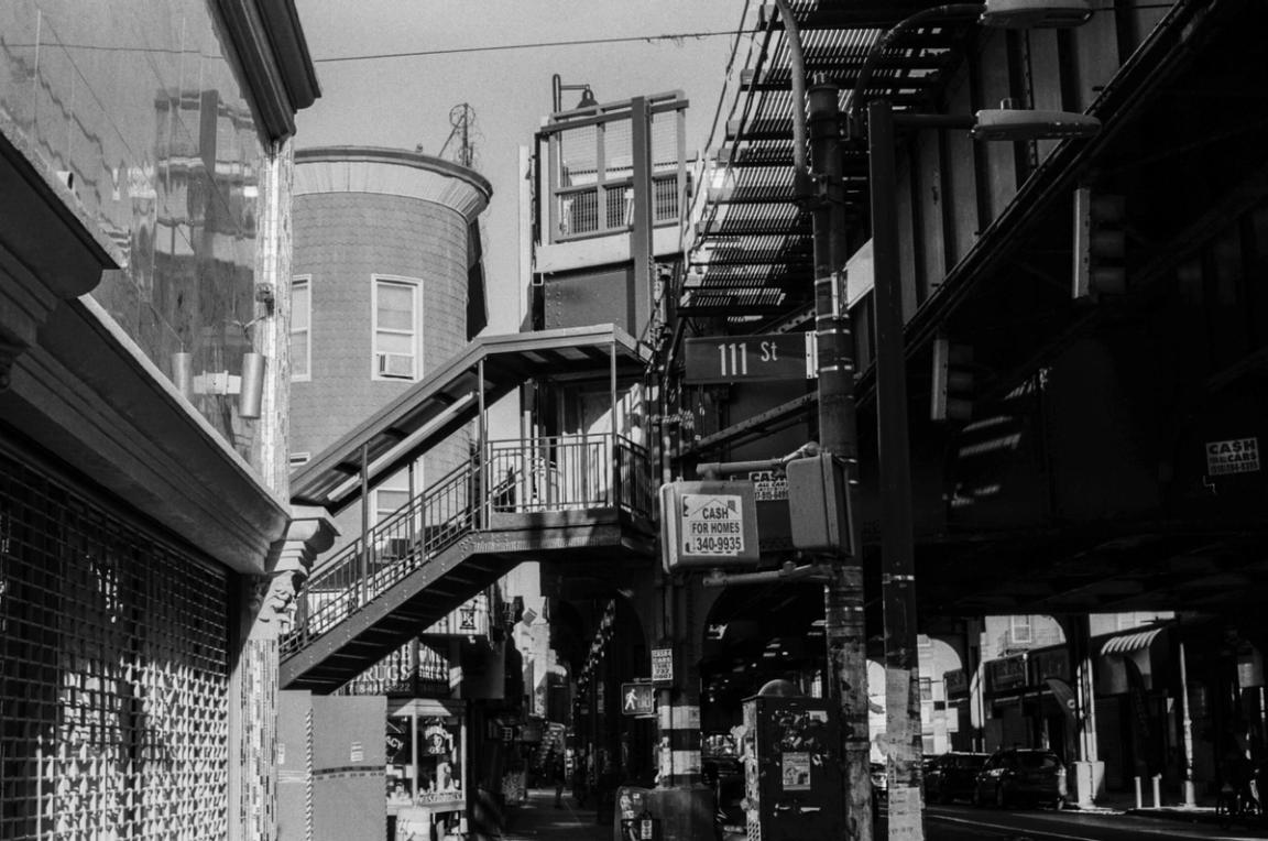 black and white image of subway overpass in Queens
