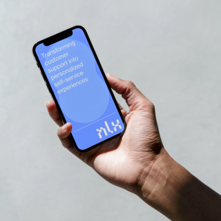 A hand holding a phone displaying NLX logo and brand slogan on a blue background.