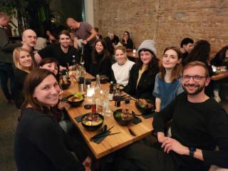 Group of people sitting at a large restaurant table