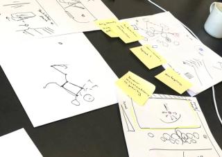 Worksheets and post-its on a black table