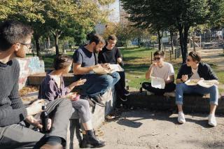 People eating together outside in a park
