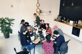People sitting together in an office kitchen having lunch at the table