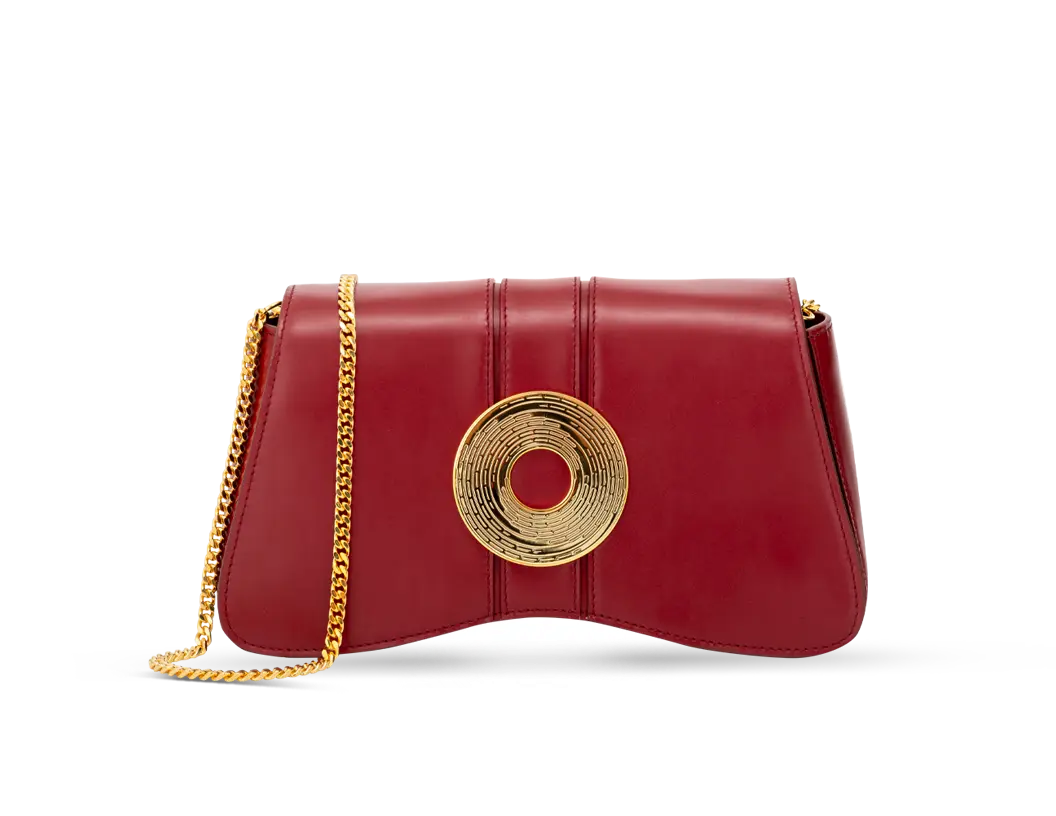 Aranyani Marquise Clutch in the fiery Lava Red Shade with a gold Monogram Medallion