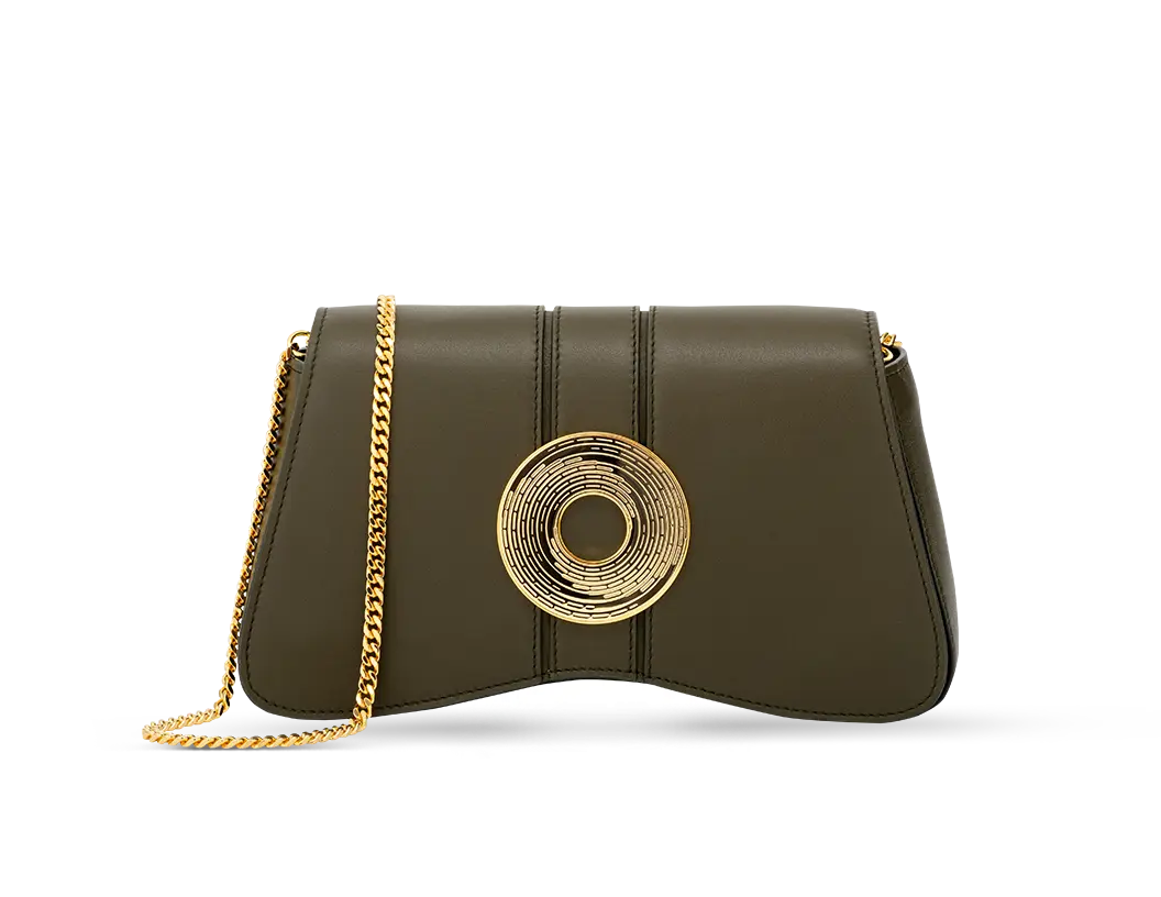 The luxurious Marquise clutch bag in the deep forest shade adorned with a gold plated Monogram Medallion
