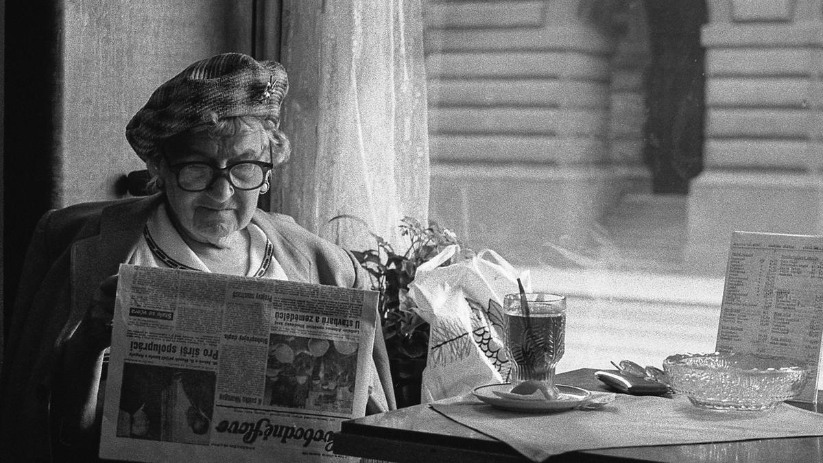 Older lady reading a newspaper