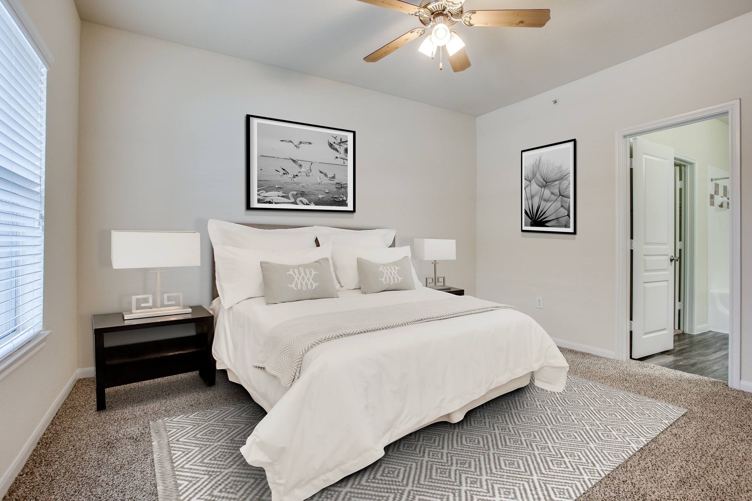 Bedroom virtually staged with queen bed, nightstands, abstract artwork, and area rug at 8818 Travis Hills Dr in Austin, Texas