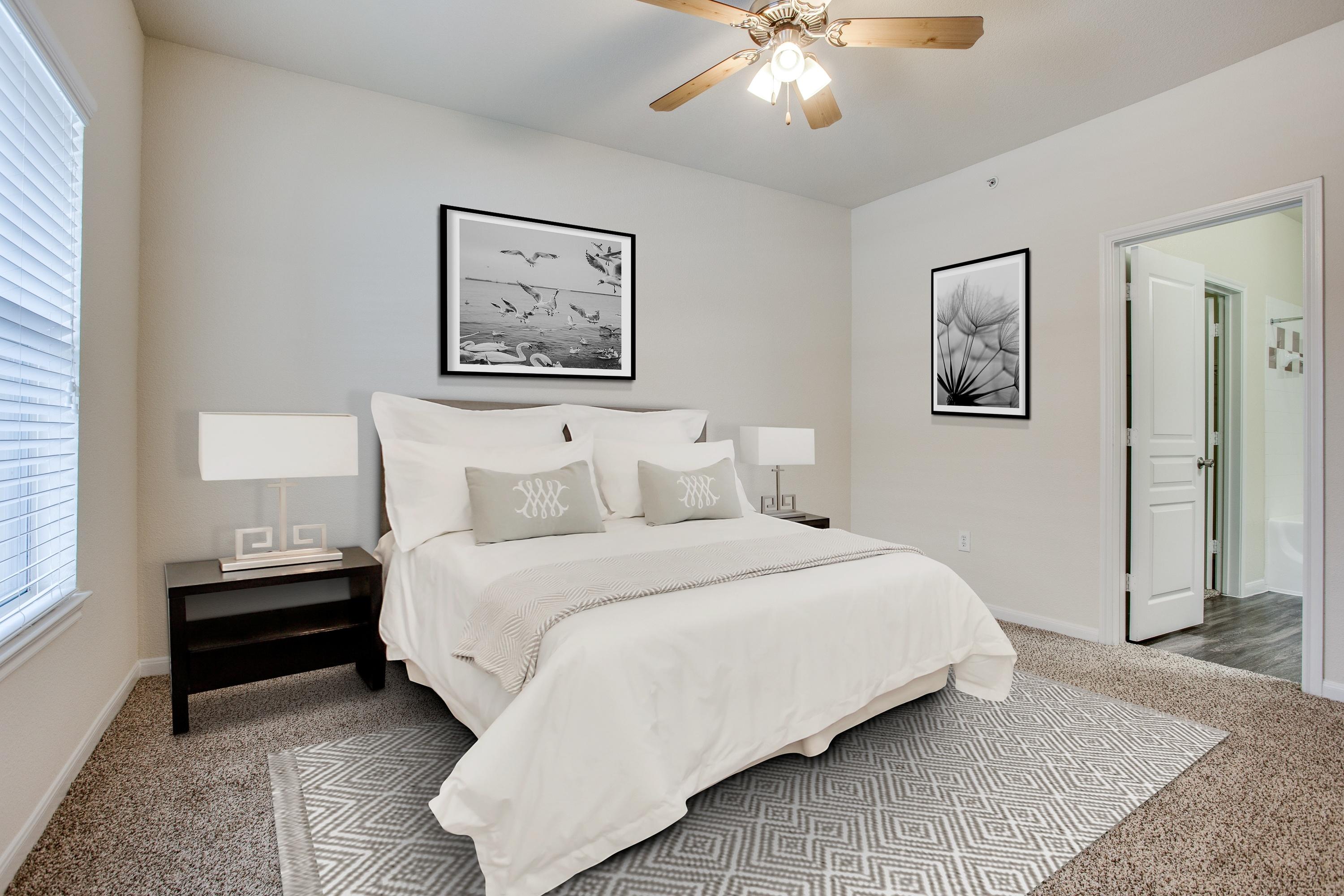 Bedroom virtually staged with queen bed, nightstands, abstract artwork, and area rug at 8818 Travis Hills Dr in Austin, Texas