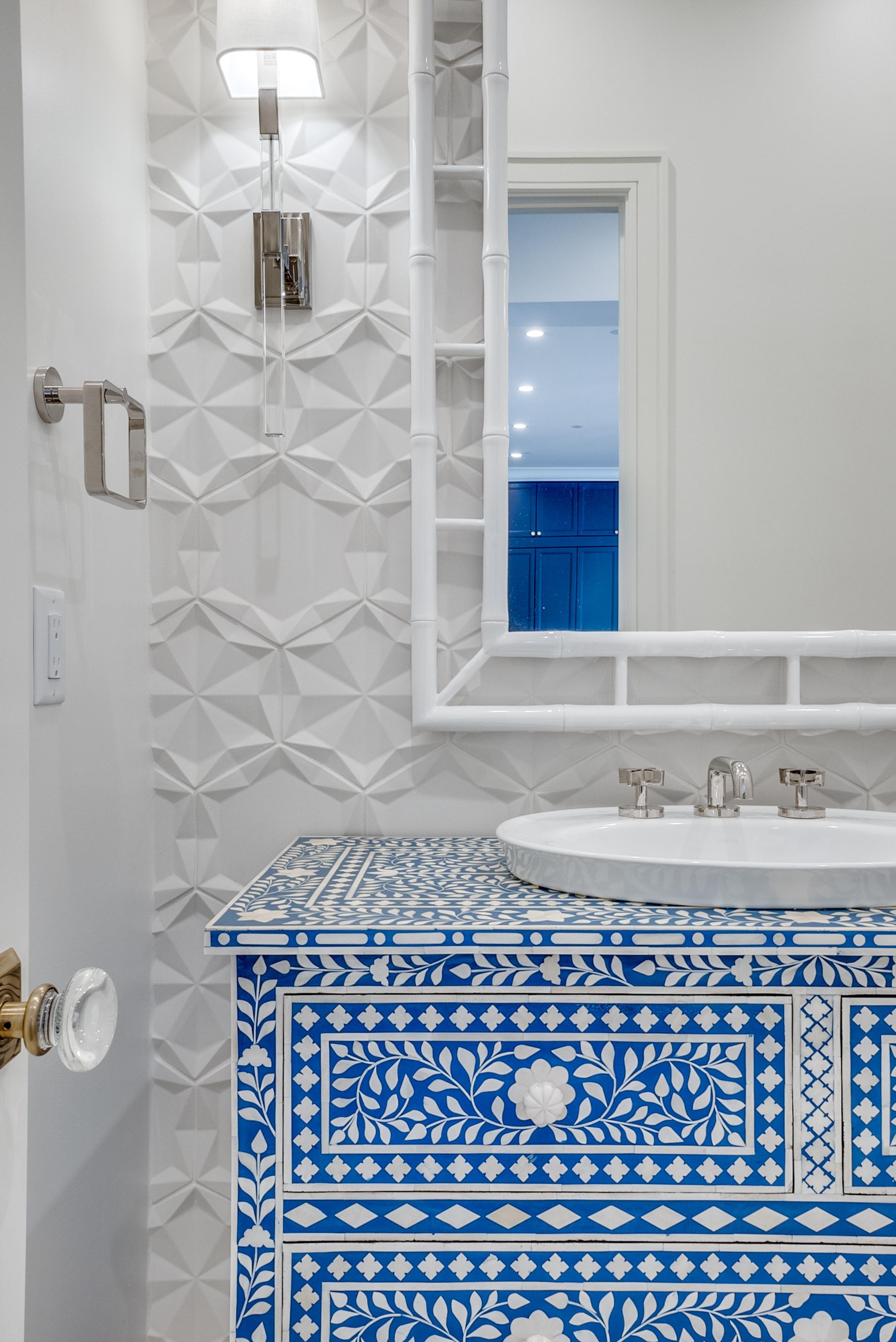 Powder room with an ornate blue-and-white bone-inlay vanity, 3D geometric white tile wall, and a round vessel sink in University Park, Texas.