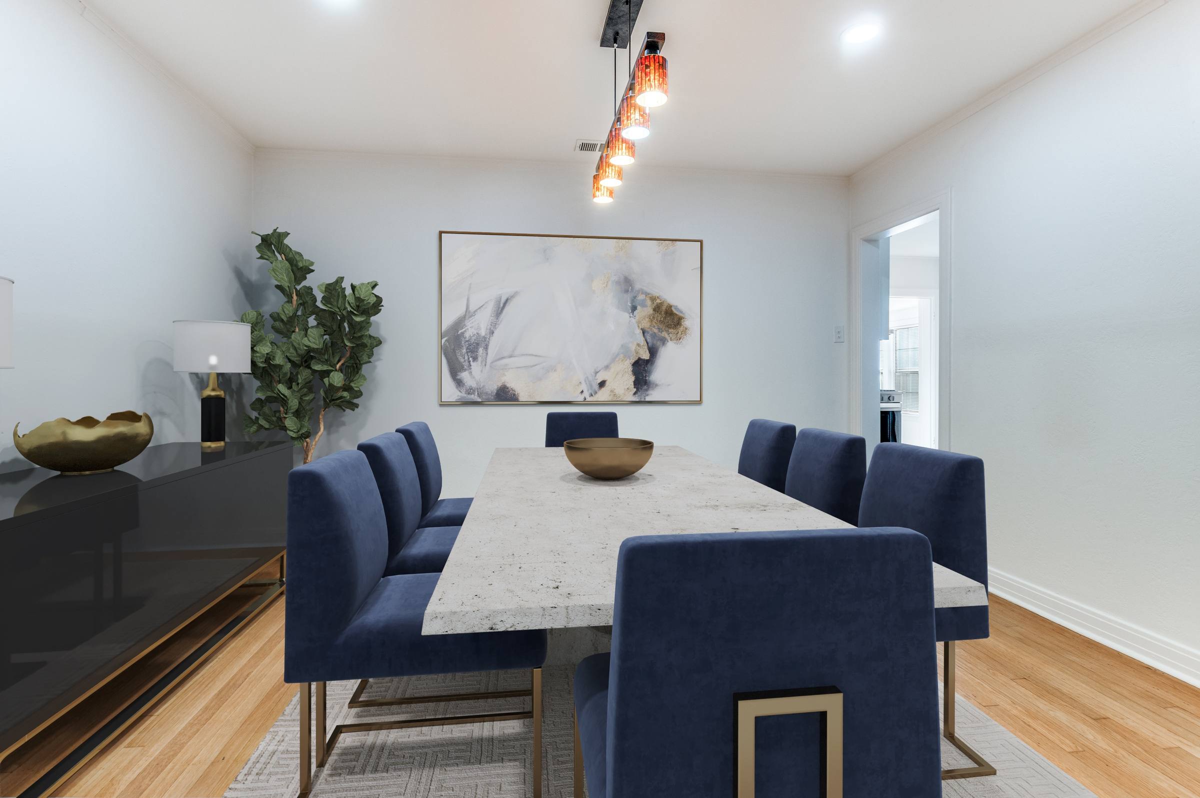 Apartment dining room virtually staged with marble table, navy velvet chairs, abstract artwork, and credenza in Dallas, Texas