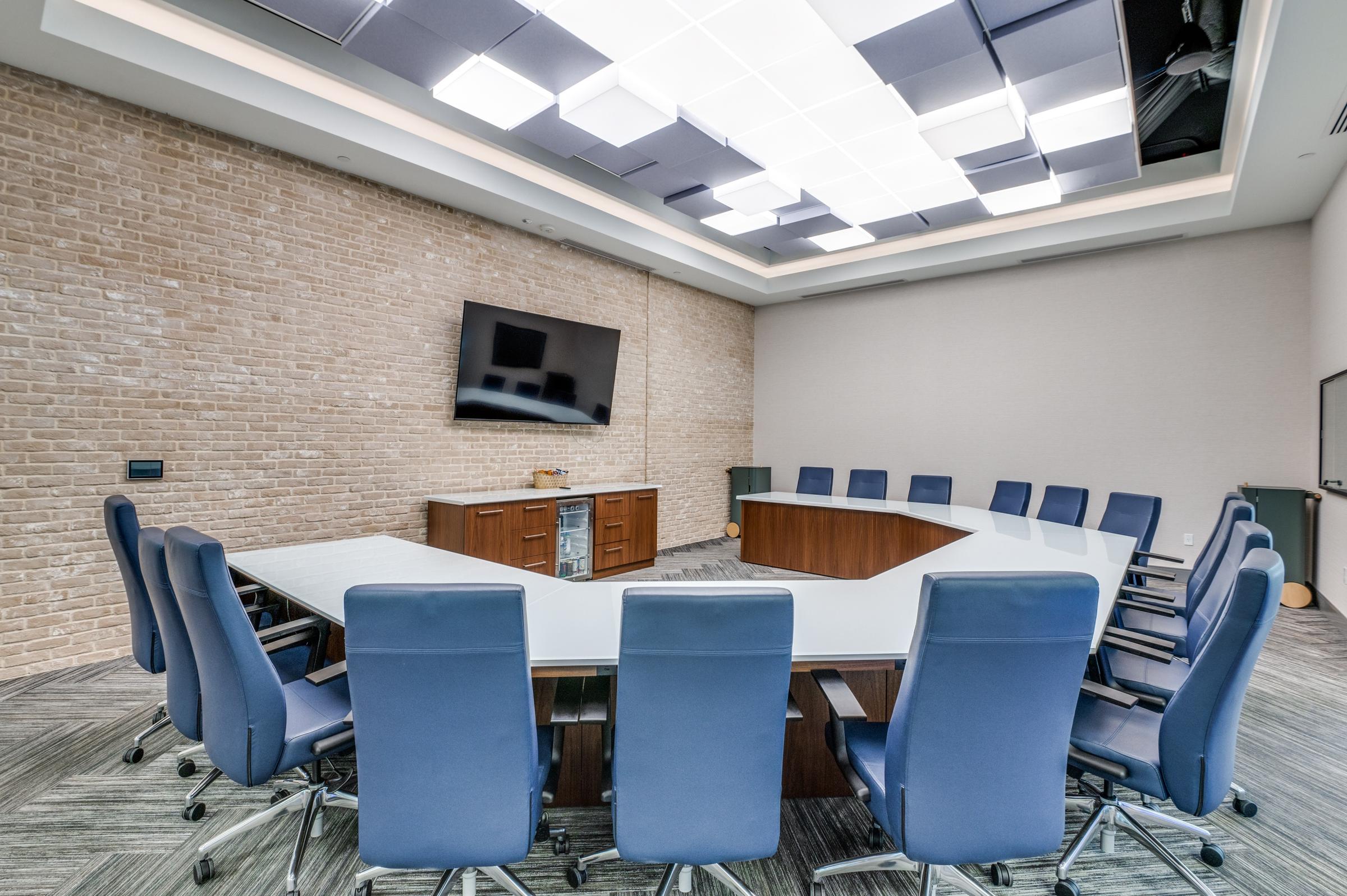 Large commercial conference room with U-shaped table and blue executive chairs in Arlington, Texas office suite