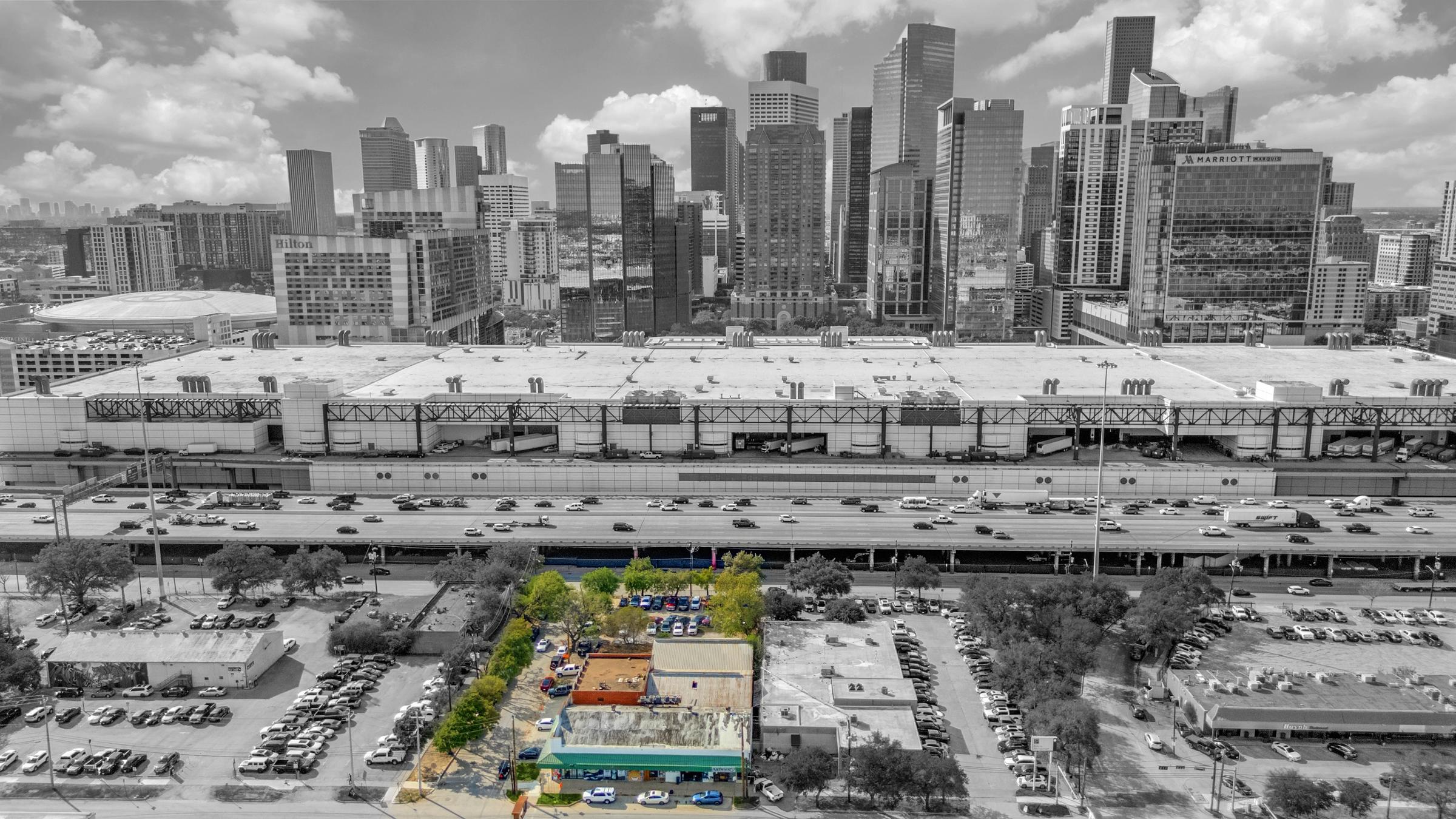 ColorPop aerial drone photography highlighting a commercial property in color against black and white Houston downtown skyline in Houston, Texas