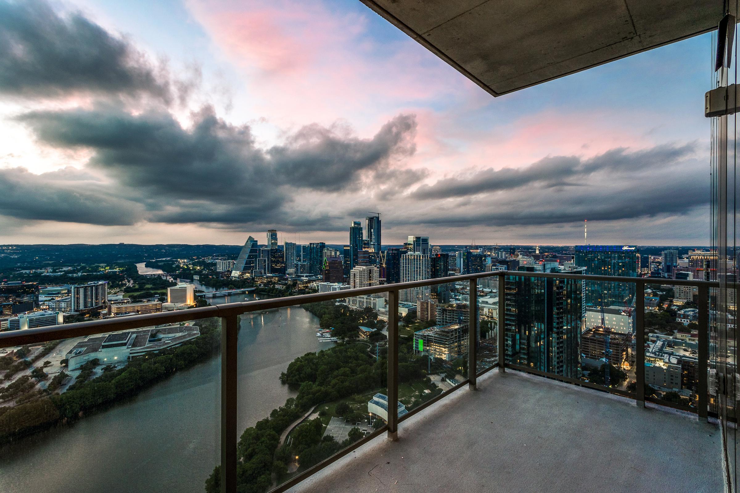 Twilight view of the downtown Austin skyline and Lady Bird Lake from a high-rise condo balcony