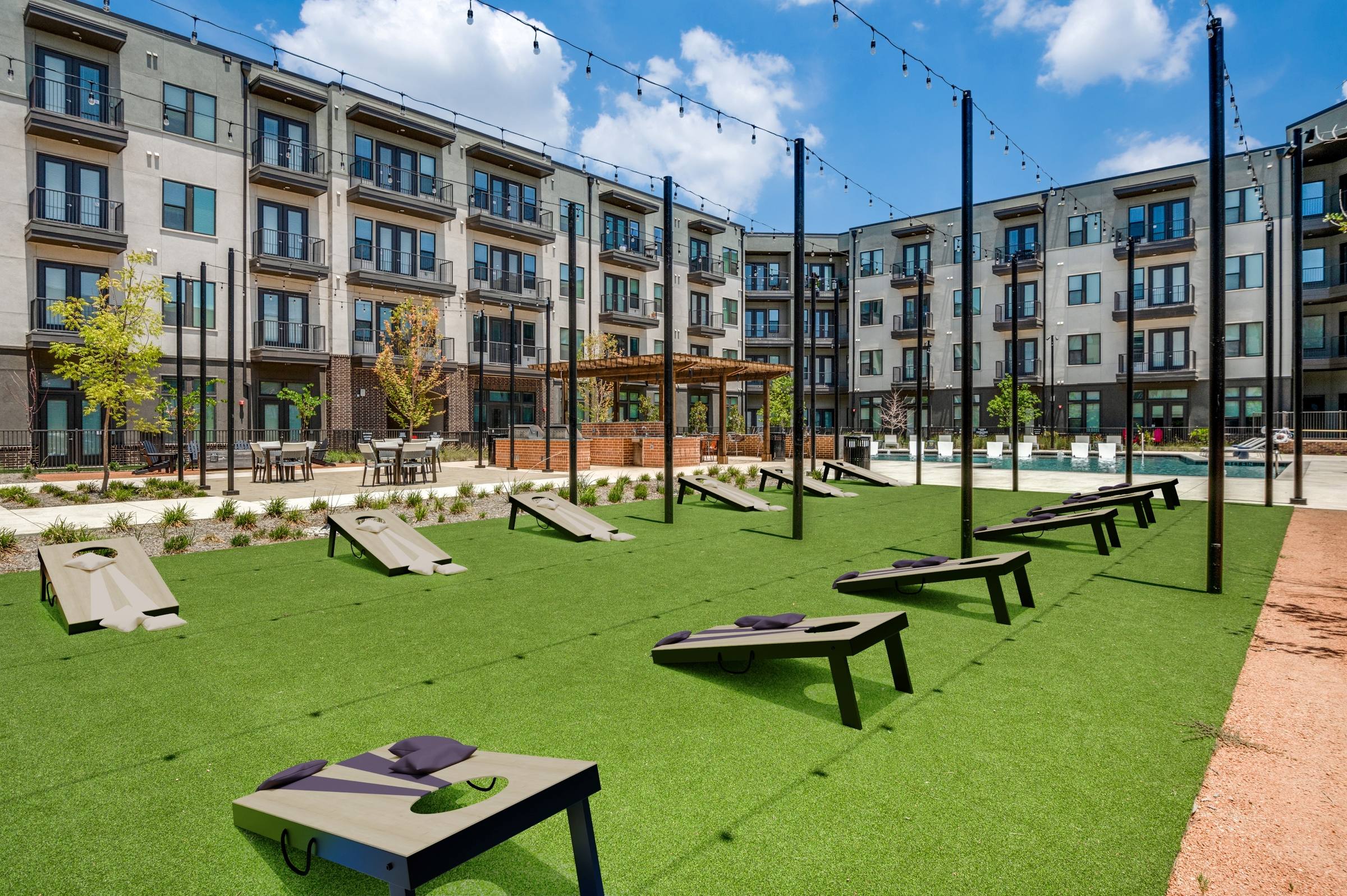 Courtyard turf area virtually staged with cornhole boards and outdoor games at 10221 Whistle Stop Ln in Frisco, Texas