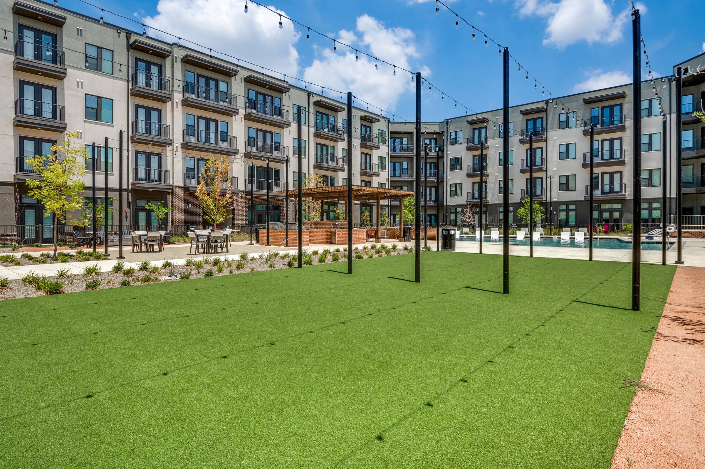 Empty courtyard turf area with fence before virtual staging at 10221 Whistle Stop Ln in Frisco, Texas