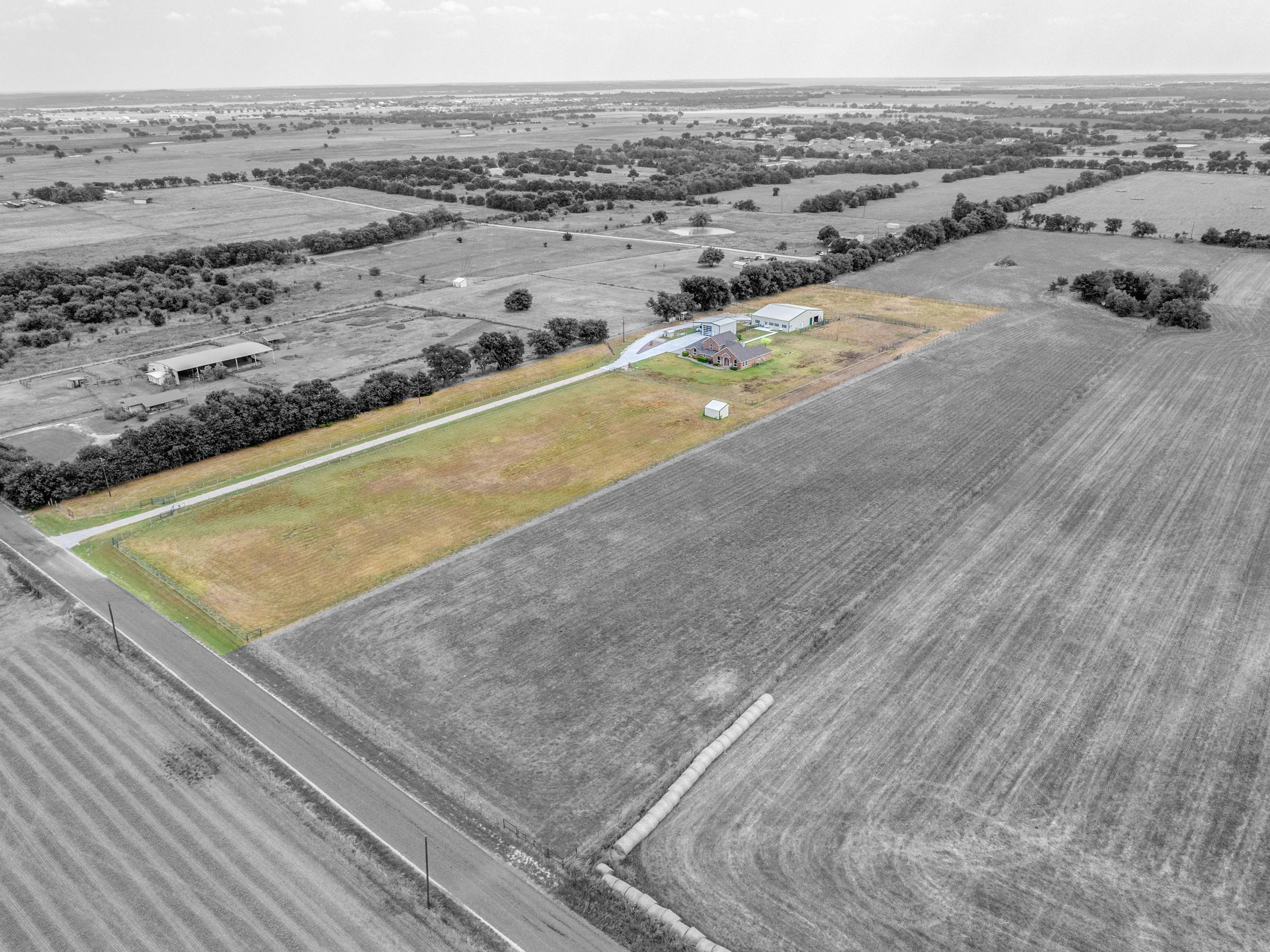 ColorPop aerial drone photography highlighting a ranch property in color against black and white rural landscape in Valley View, Texas