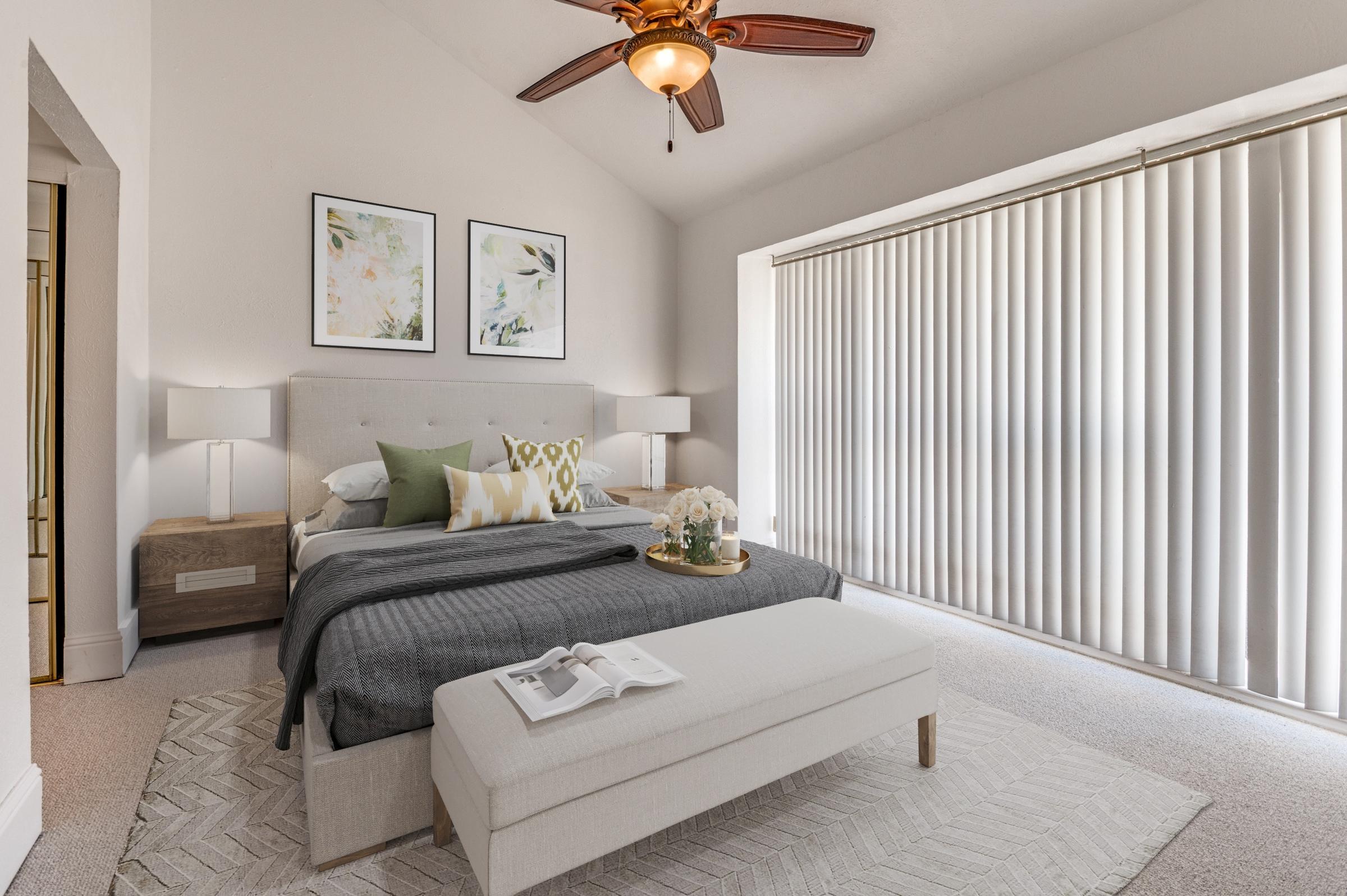 Virtually staged condo bedroom with upholstered bed, nightstands, botanical art, and area rug in Irving, Texas