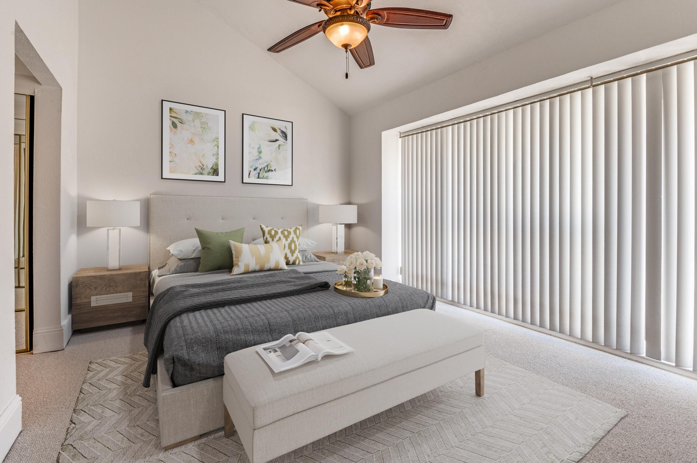 Virtually staged condo bedroom with upholstered bed, nightstands, botanical art, and area rug in Irving, Texas