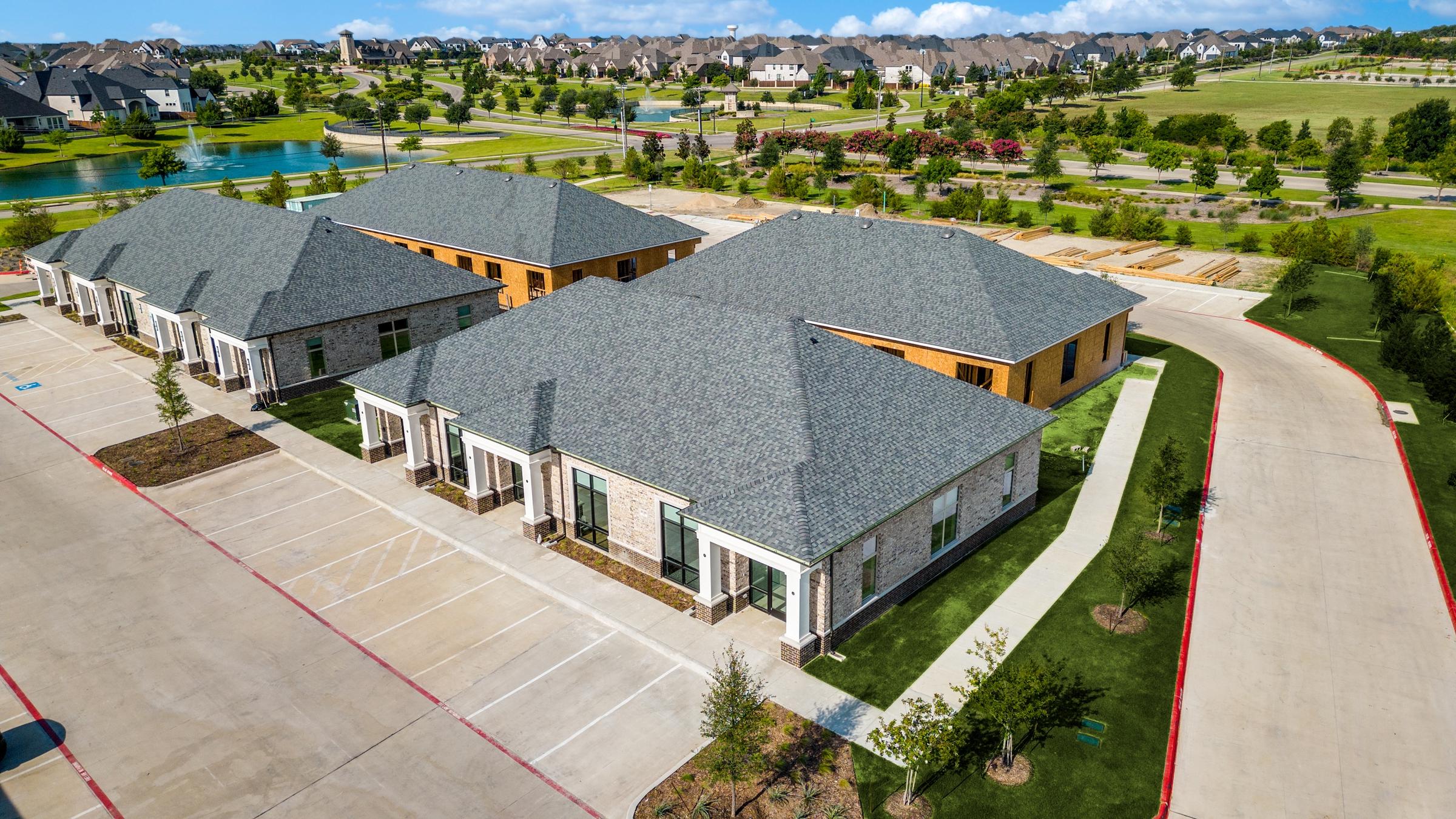 Aerial view of new commercial office suites with pond and community amenities in Prosper, Texas