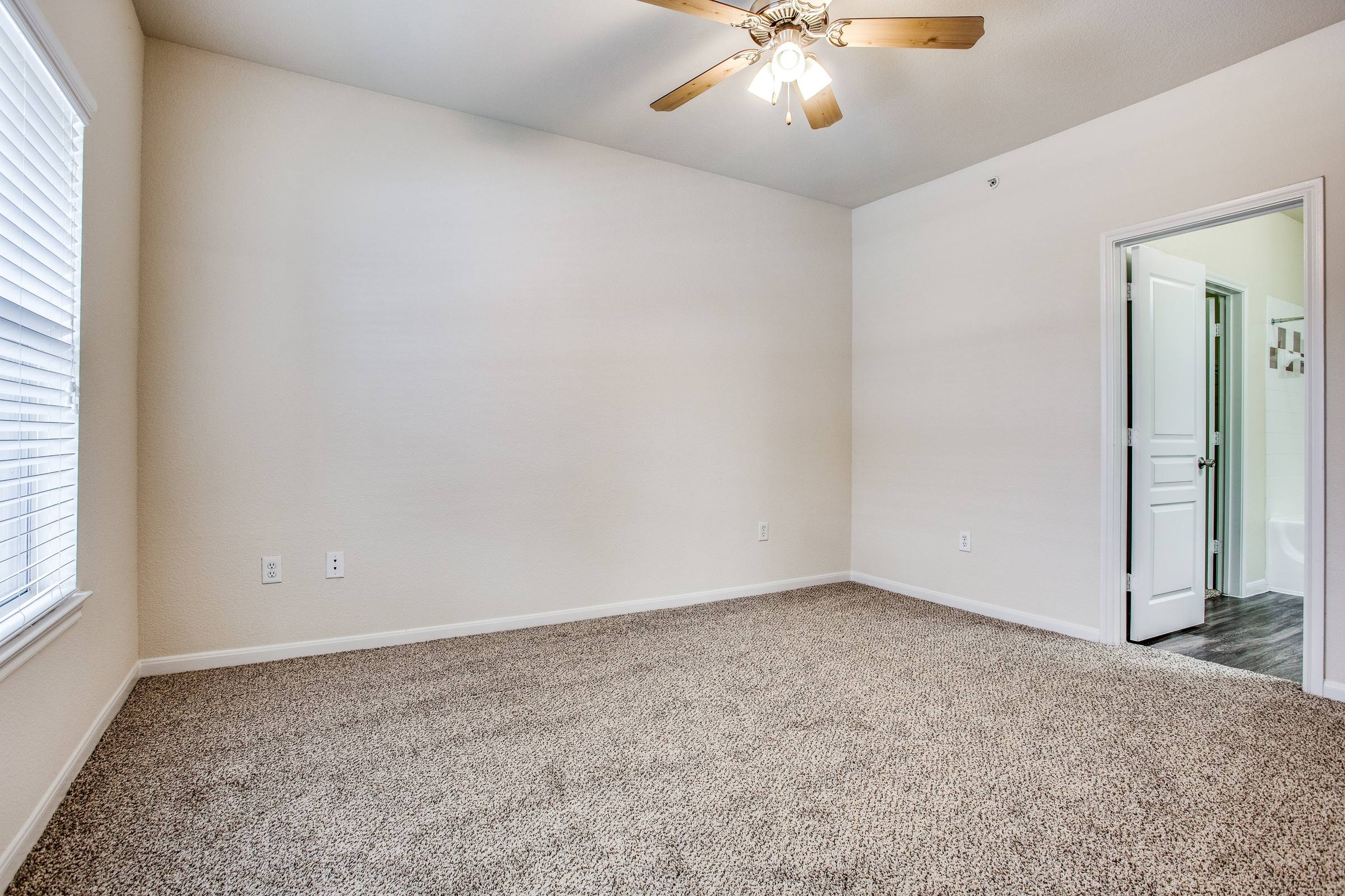 Empty bedroom with ceiling fan and natural light before virtual staging at 8818 Travis Hills Dr in Austin, Texas