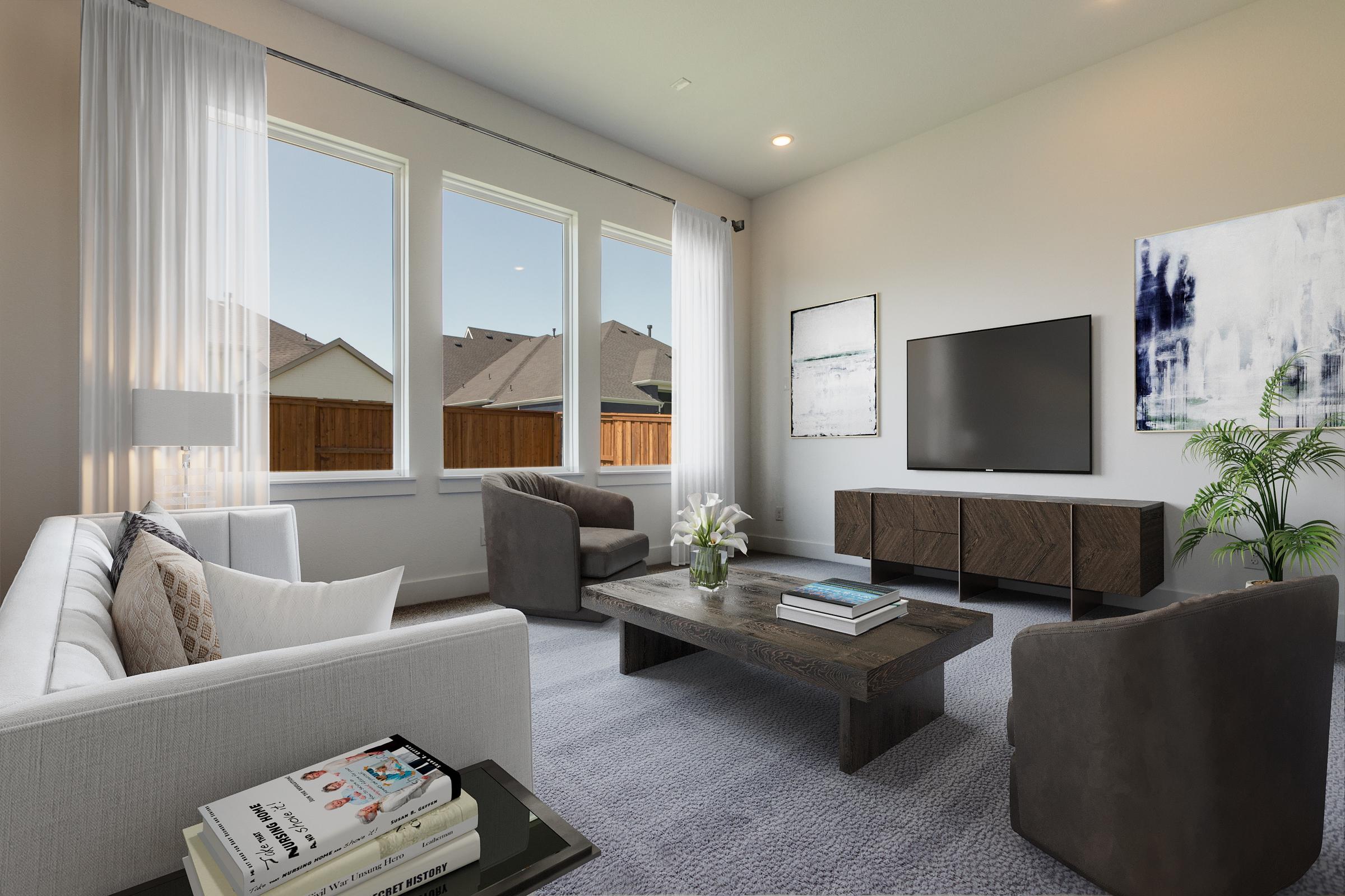 Virtually staged living room with modern gray sofas, wooden coffee table, and TV console in new construction home in Prosper, Texas