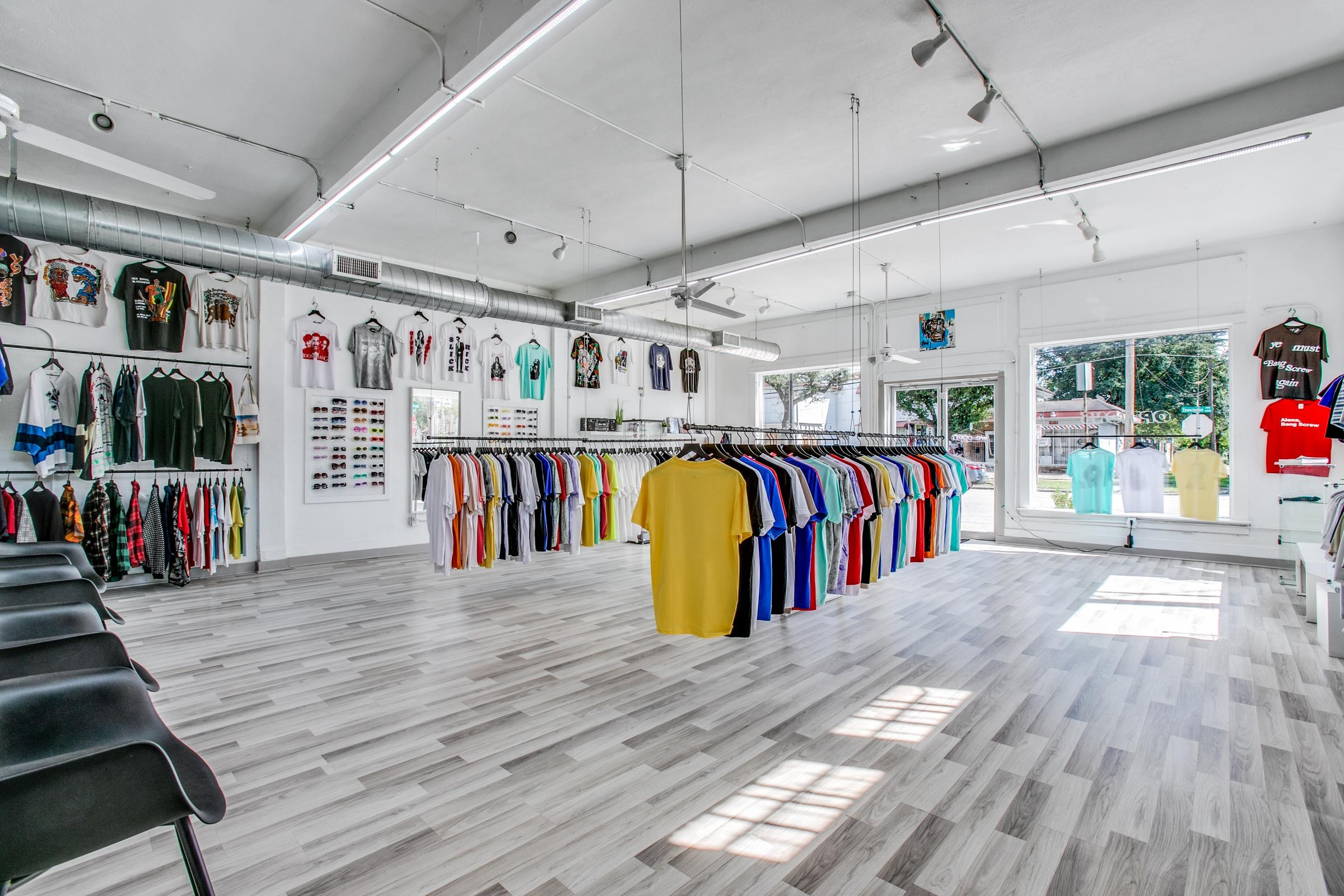 Modern retail clothing store interior with exposed ductwork and merchandise displays in Houston, Texas