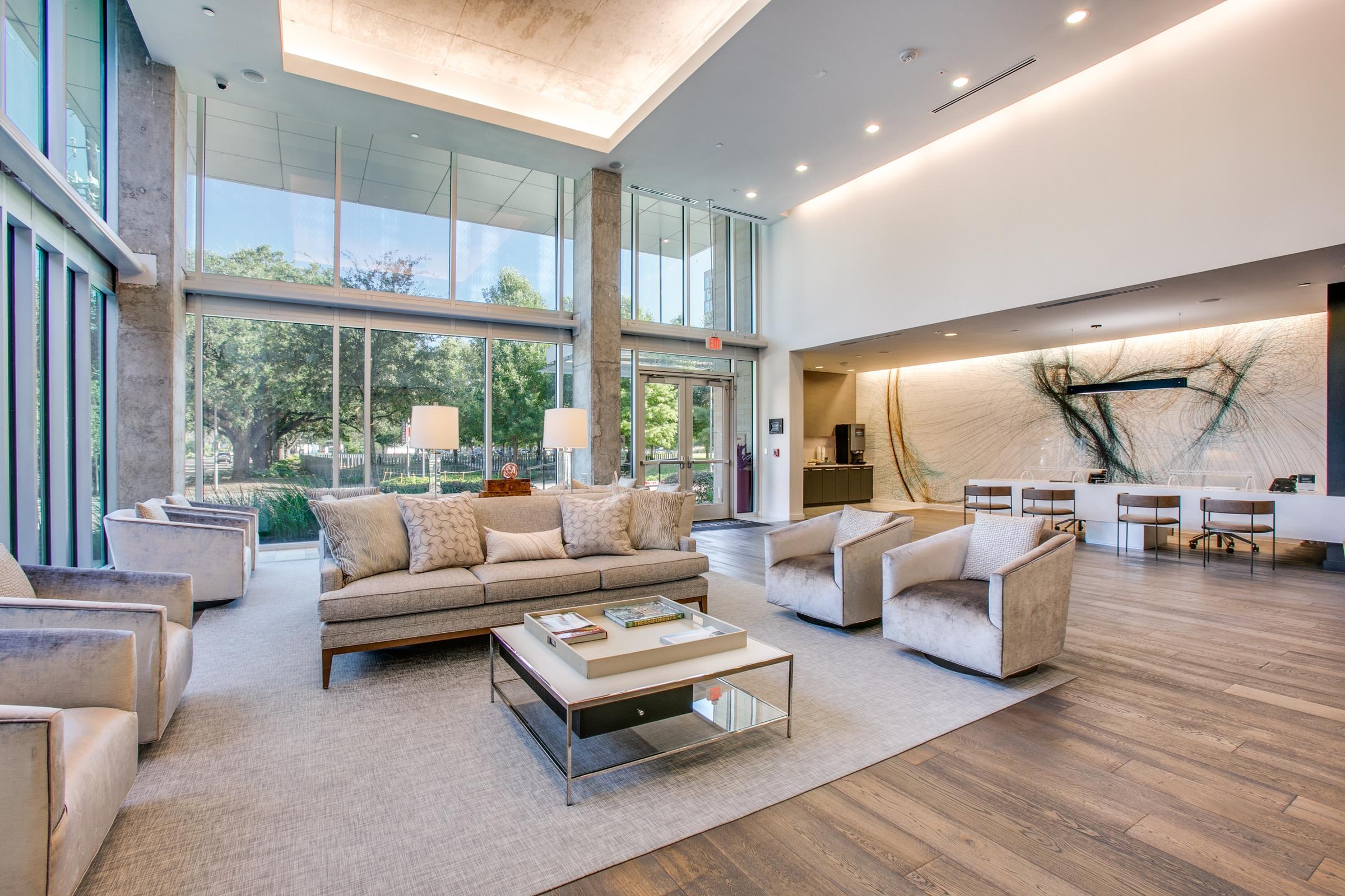 Luxury commercial lobby with double-height ceilings, floor-to-ceiling windows, and modern furniture in Houston, Texas