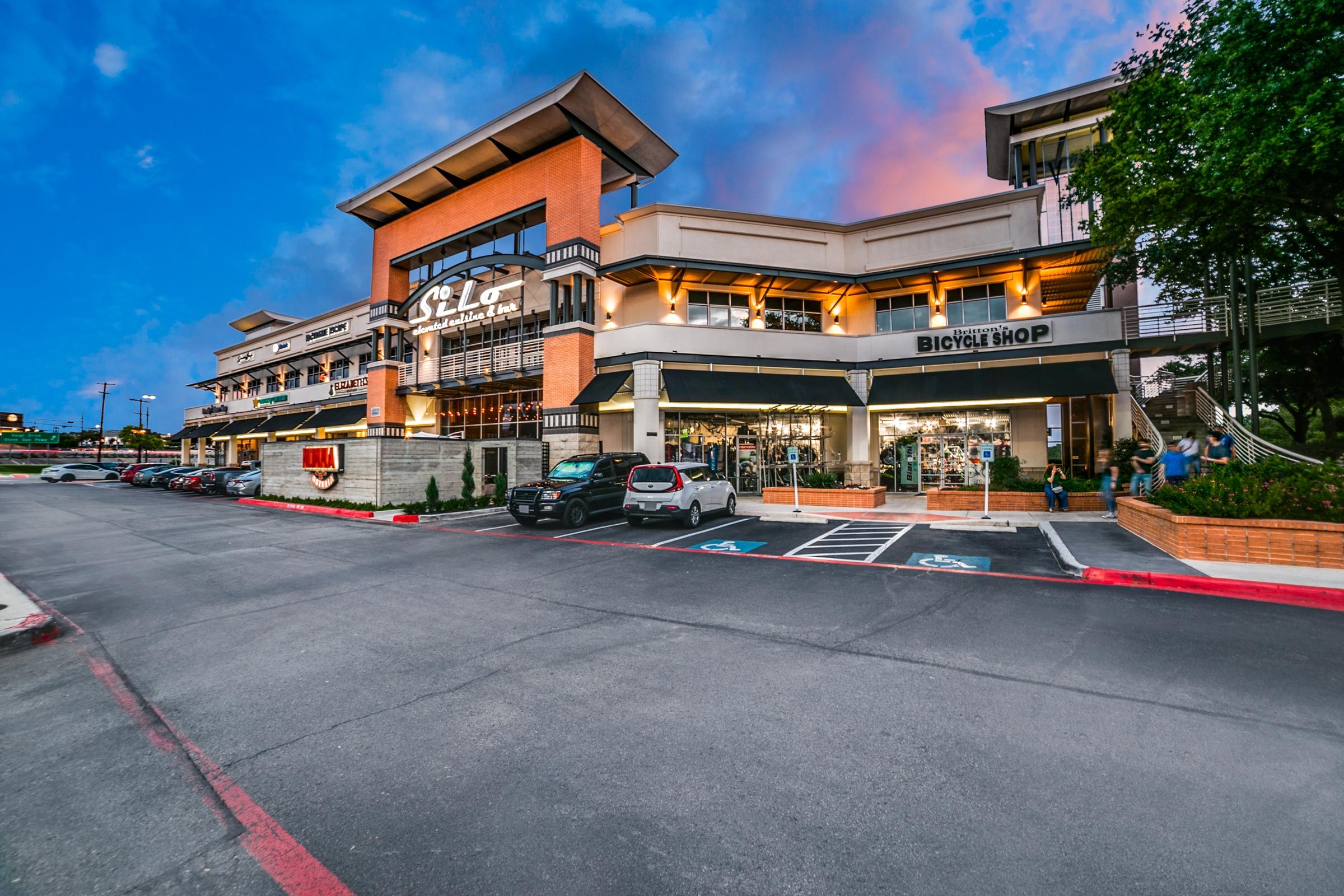 Multi-level outdoor shopping mall with retail shops and restaurants at twilight in San Antonio, Texas