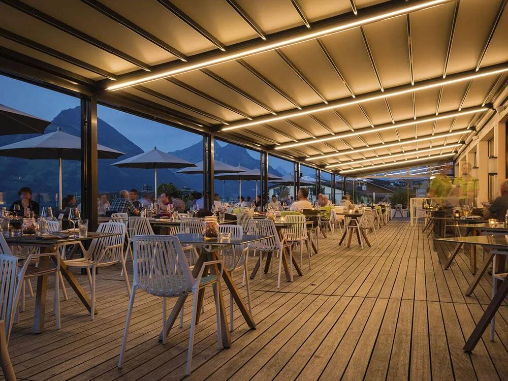 Convertible indoor outdoor event space with retractable roof open to the sky