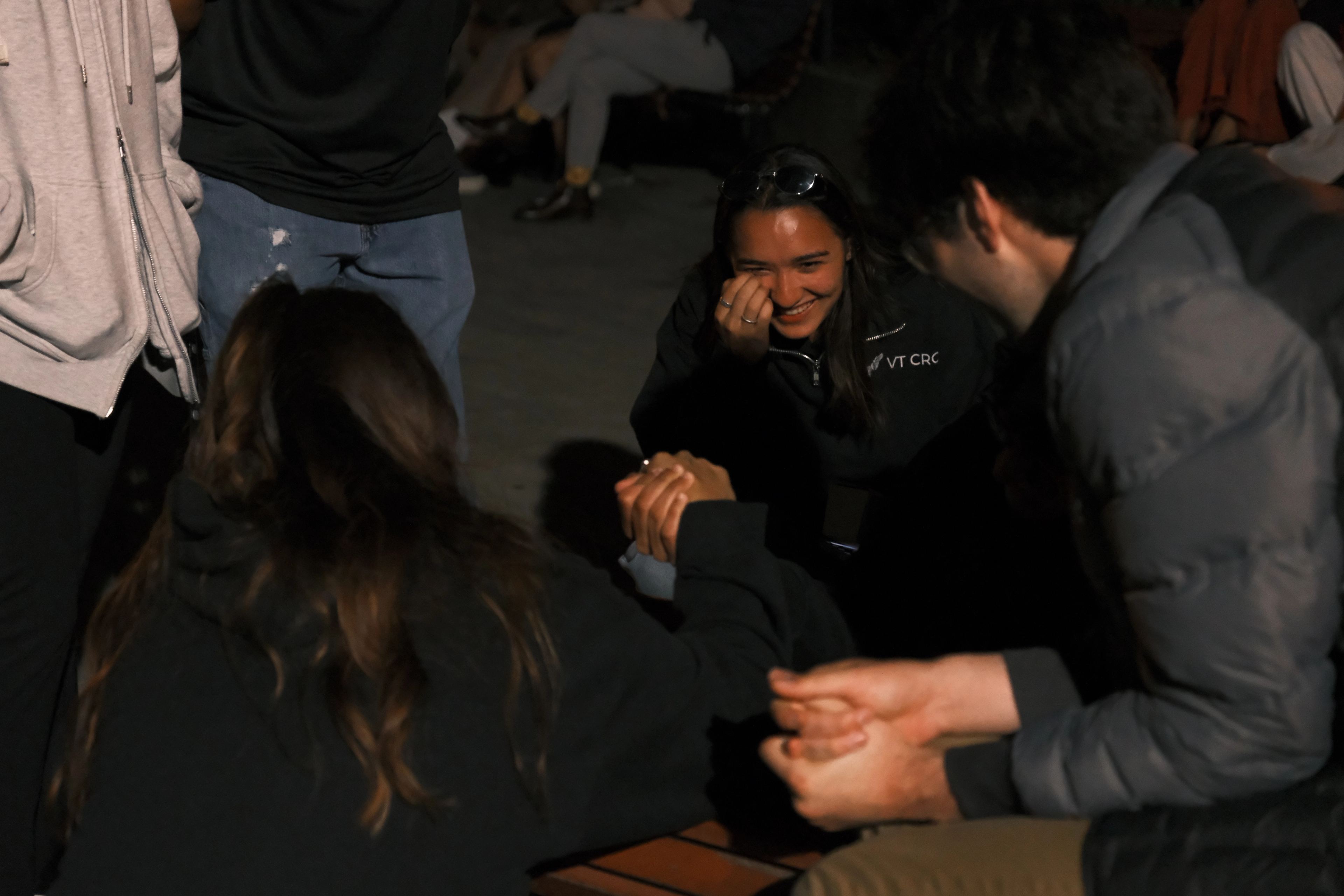 Members laughing together at an evening gathering