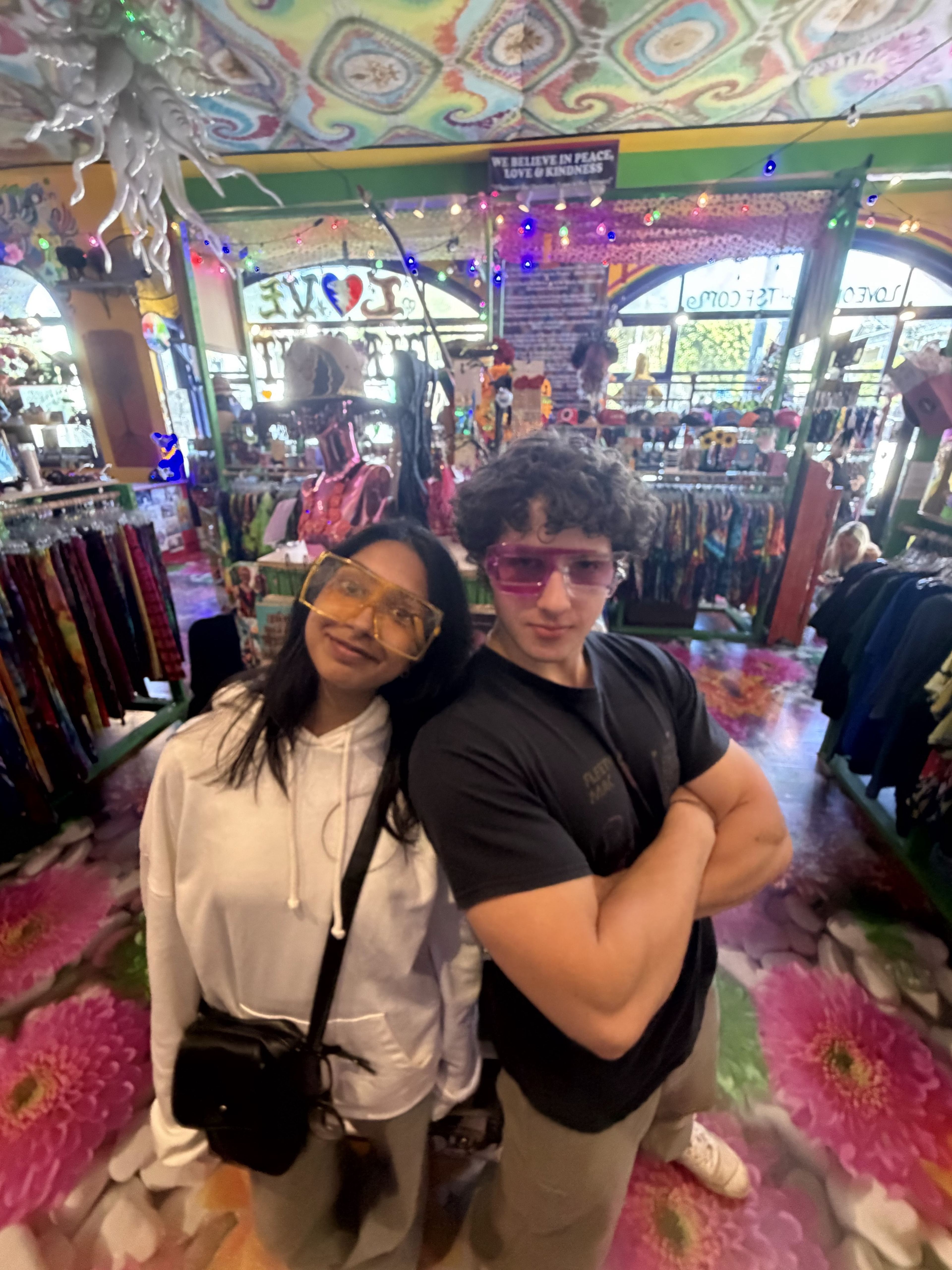 Two members posing in a colorful shop