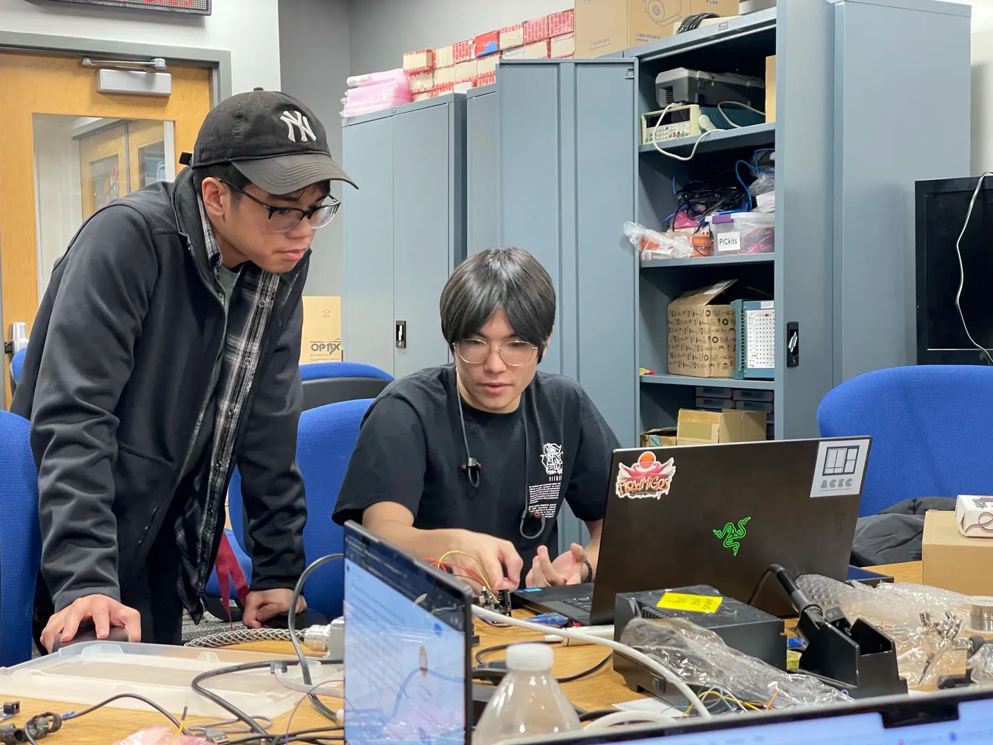 Members debugging electronics in the lab