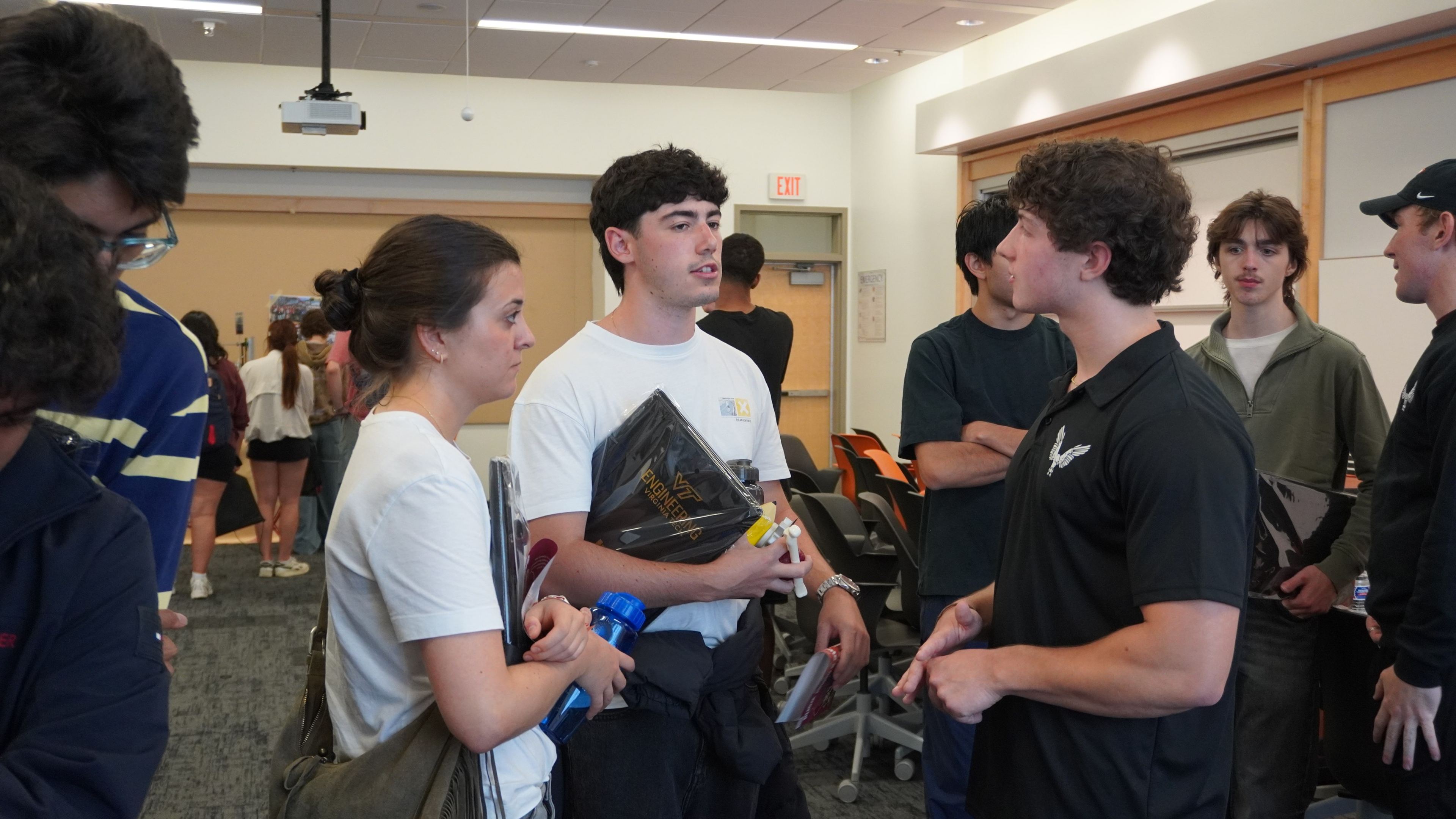 A member talking with students at the showcase