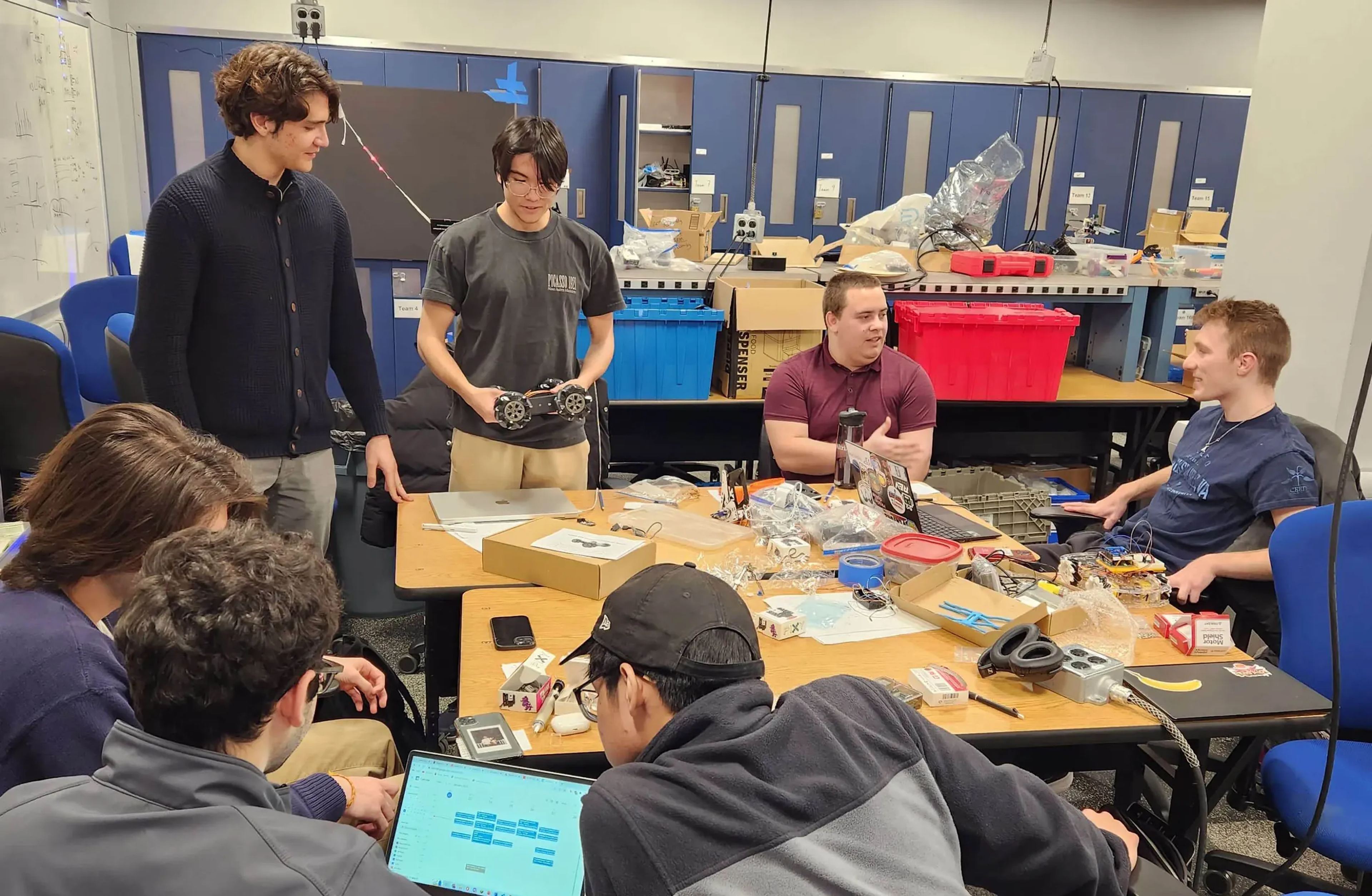 Members gathered around a lab table